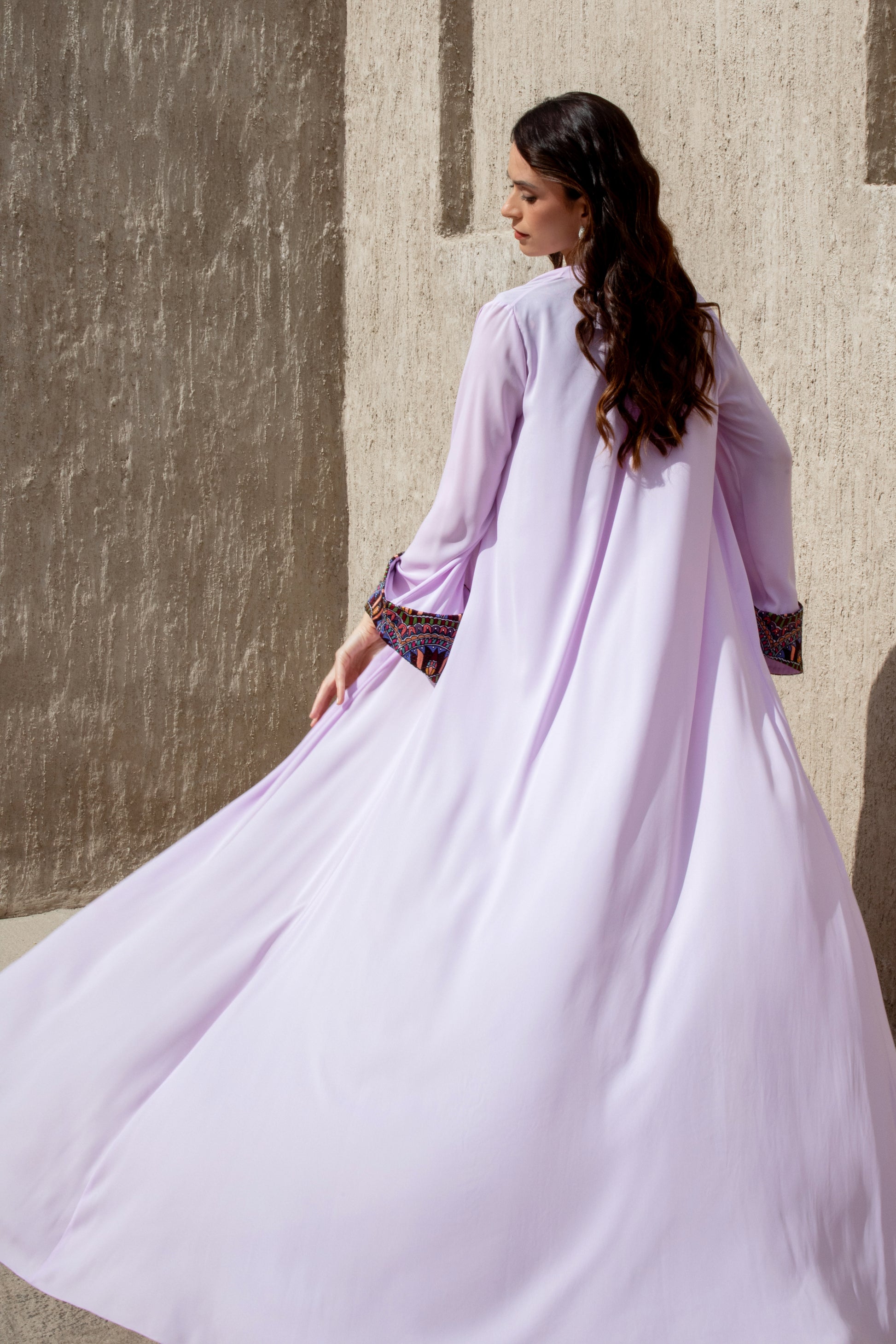 Back of Amethyst Haze jumpsuit with cape-style jacket in motion