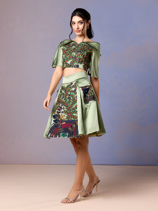 Women wearing sage green two-piece skirt set with embroidered crop top and short flared skirt