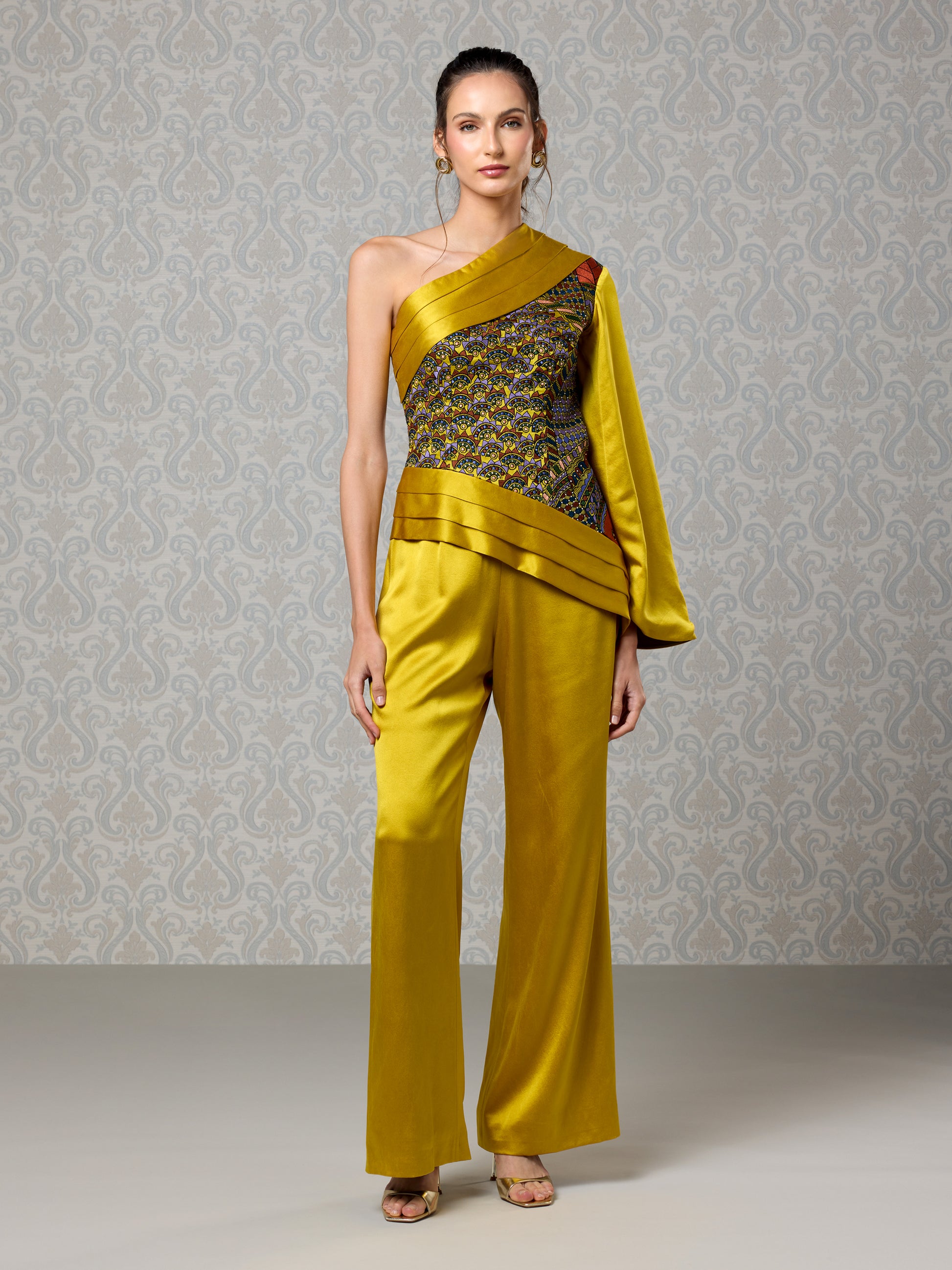 Front view of harvest gold silk satin one-shoulder jumpsuit with embroidered bodice