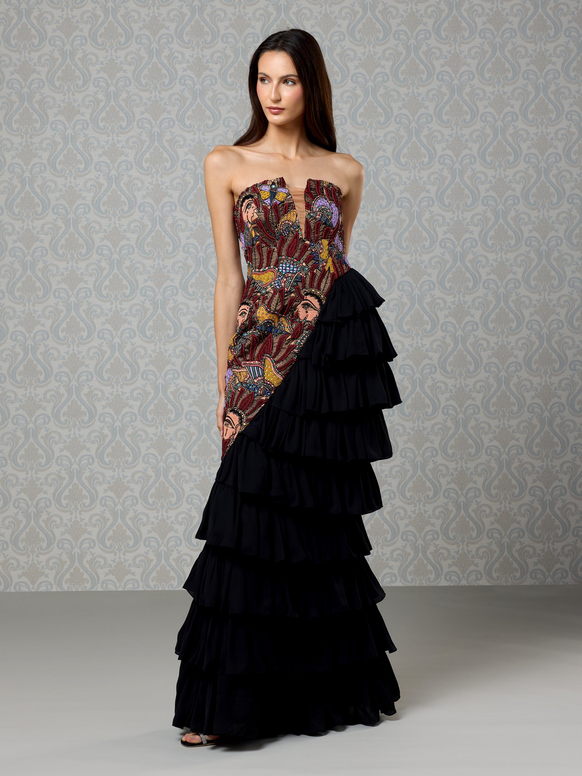 Side pose in strapless Black Ice satin gown with cascading ruffle crepe skirt
