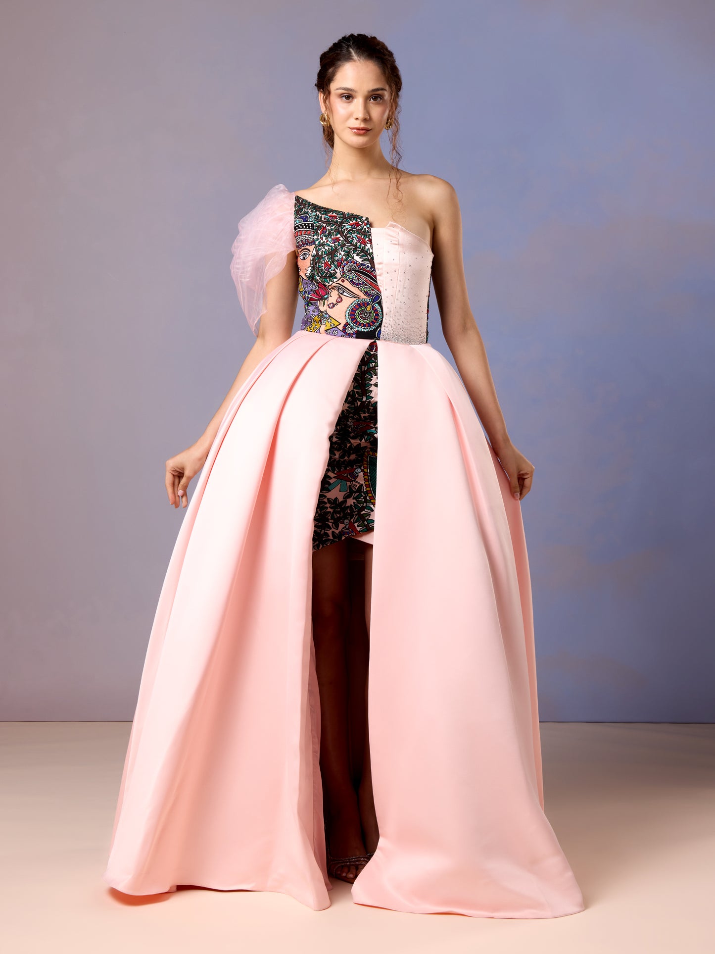 Women wearing one-shoulder coral blush gown with dramatic flare