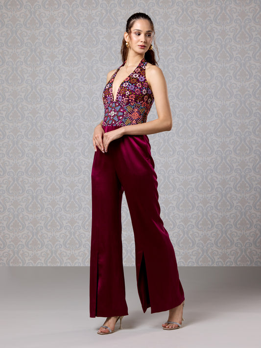 Full-length cranberry jumpsuit with deep V-neck and embroidered bodice