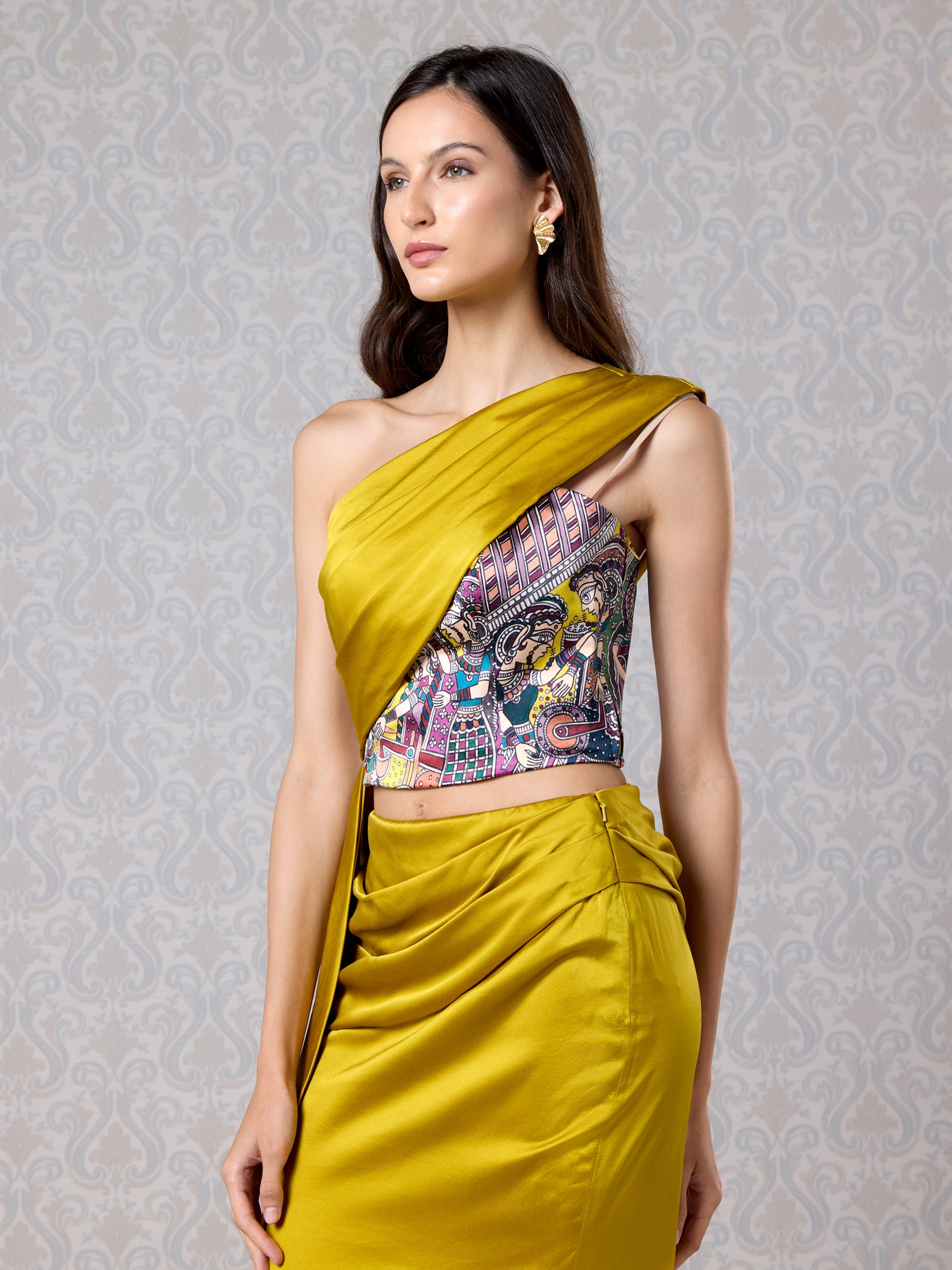 Model in harvest gold silk satin co-ord set with draped shoulder detail