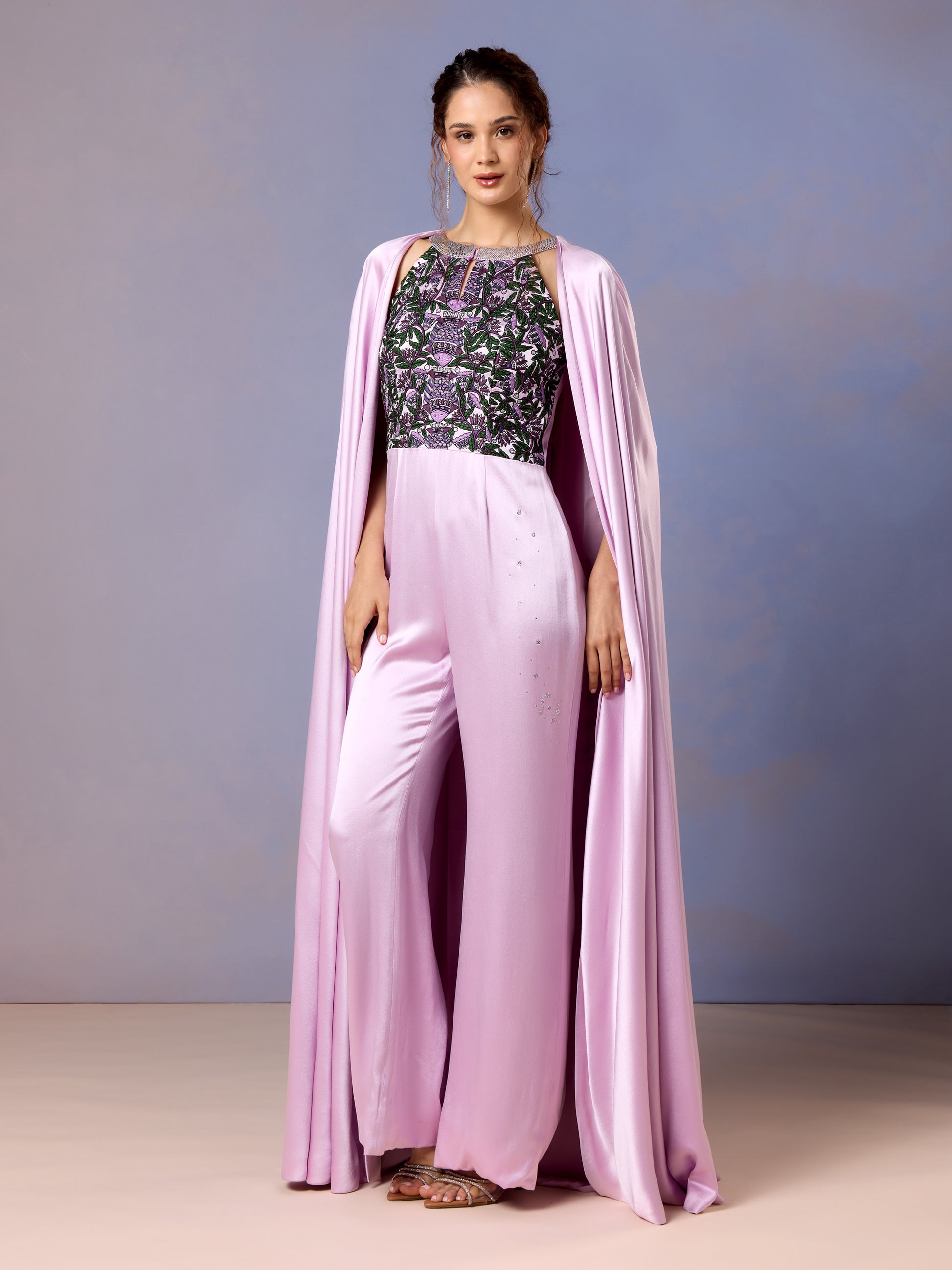Model posing in cape-style French lilac jumpsuit with flared pants