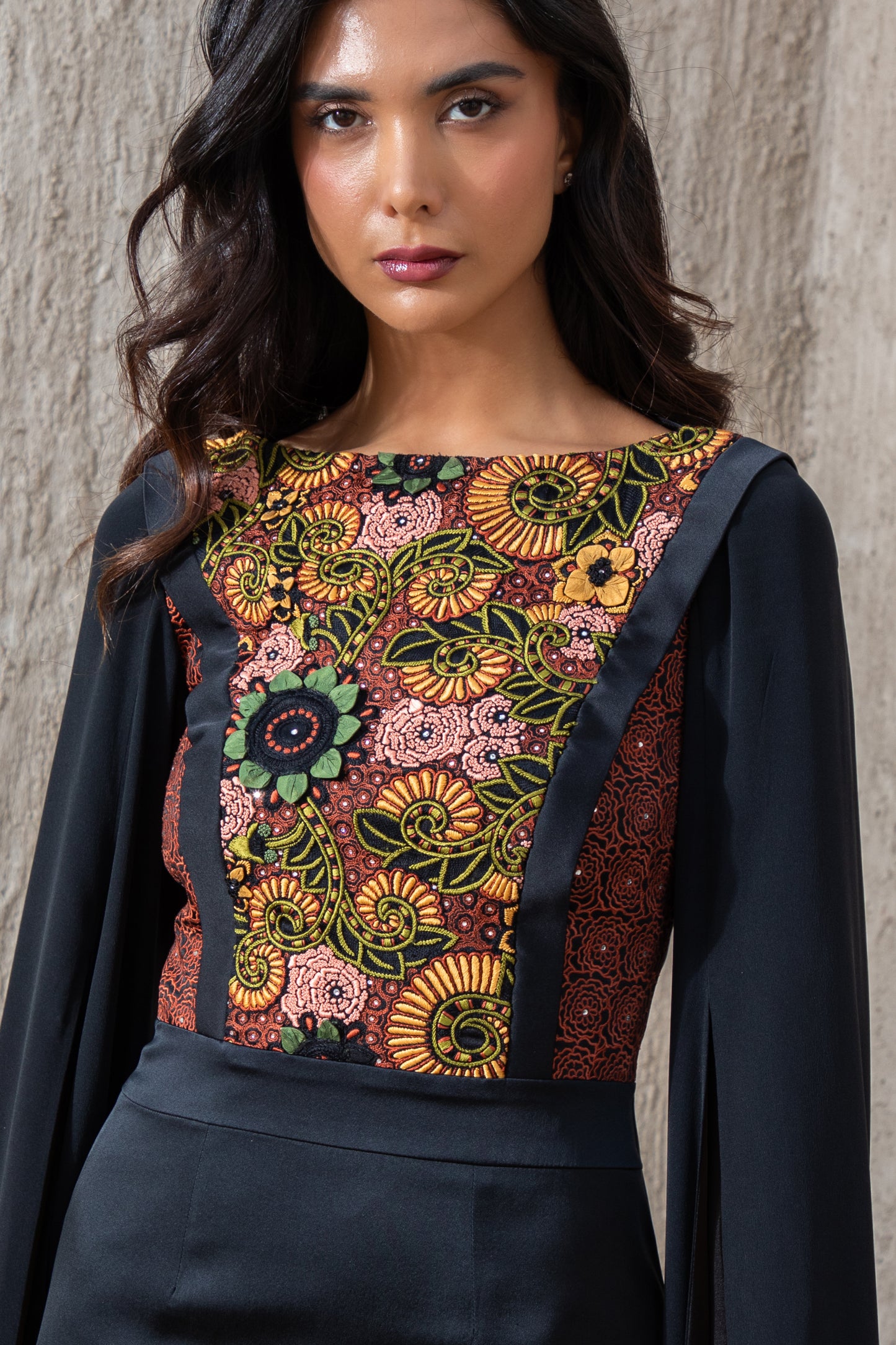 Close-up of colorful floral embroidery on black evening gown