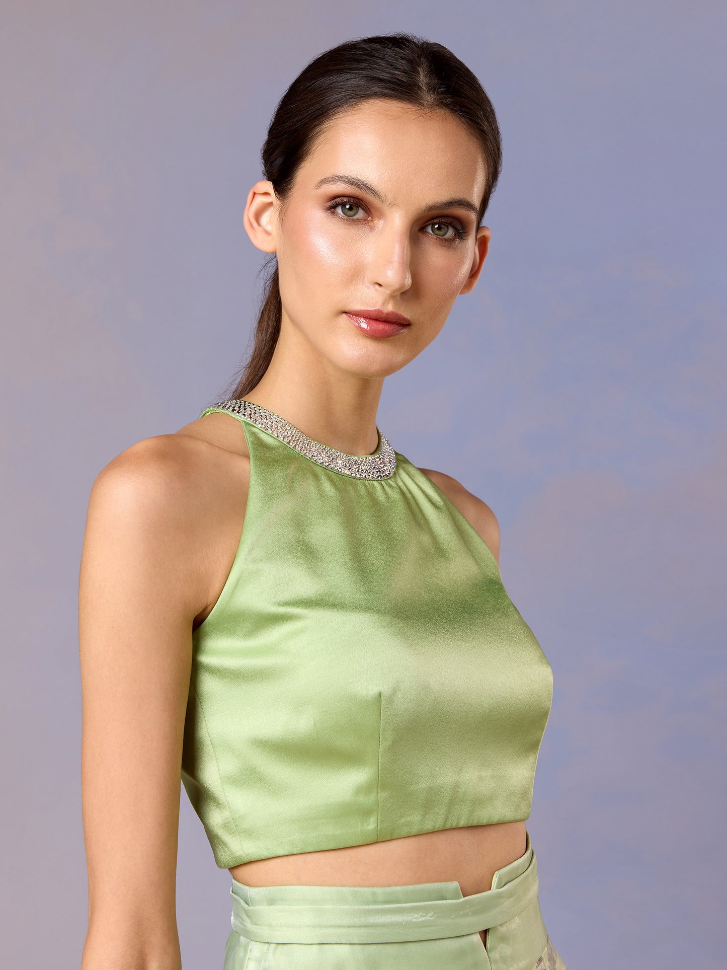 Close-up of Sage Whisper green sleeveless crop top with satin finish