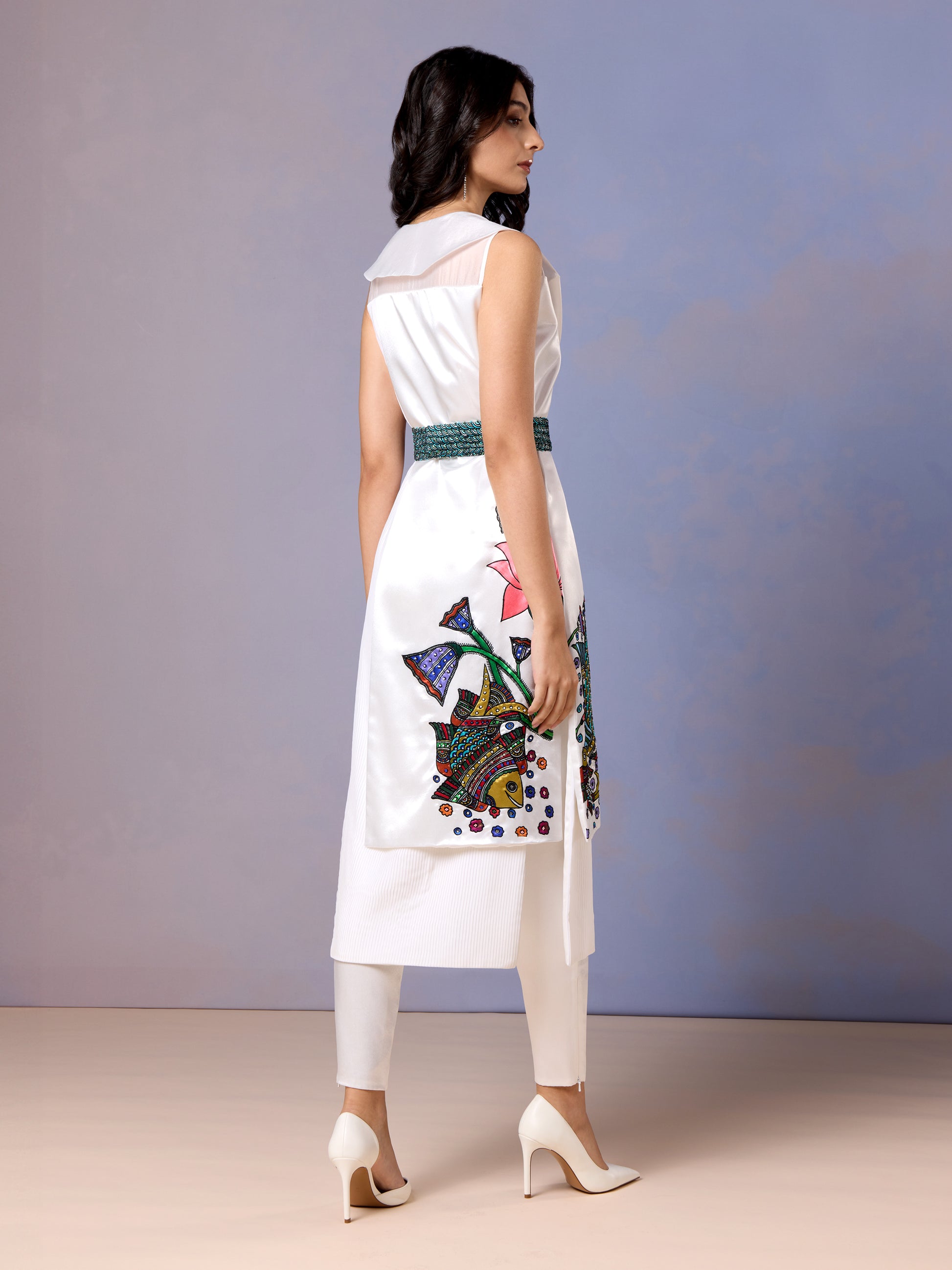 Back view of sleeveless white kurti and straight pants with embroidered waistband