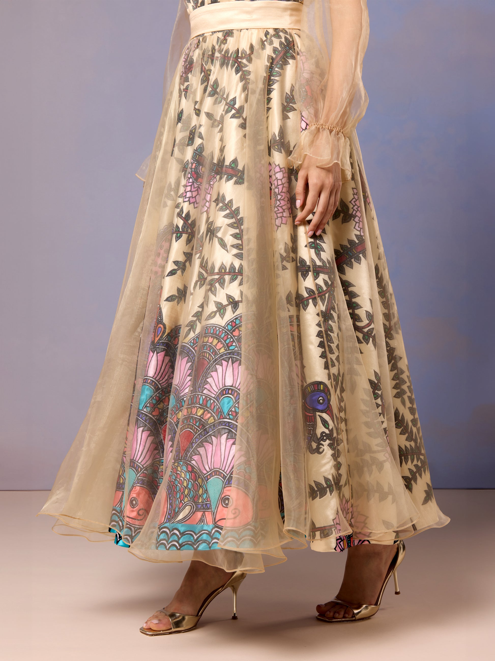Side view of yellow long dress with flowy hem and printed floral detailing