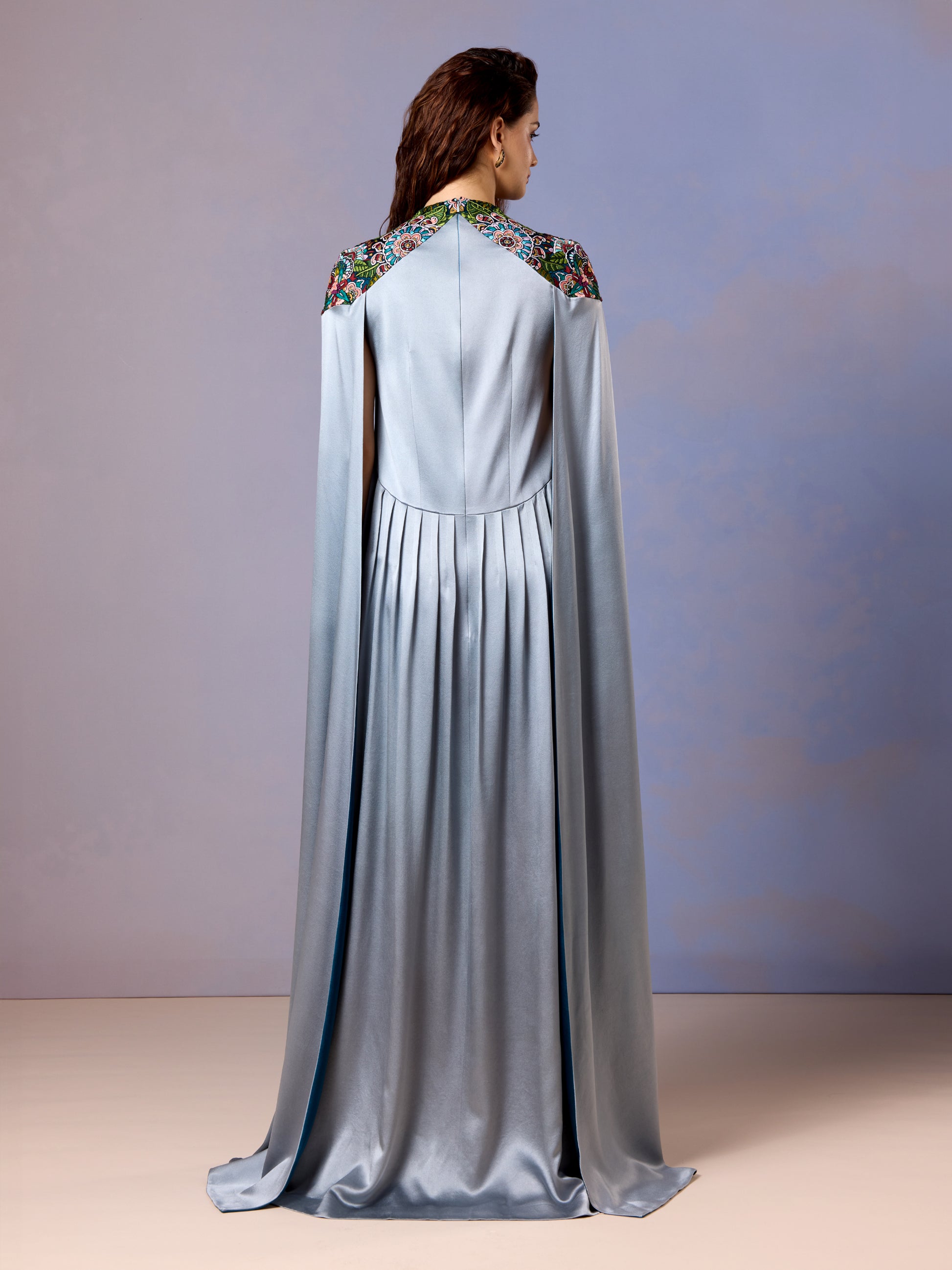 Back view of glacier blue silk kaftan with elegant drape