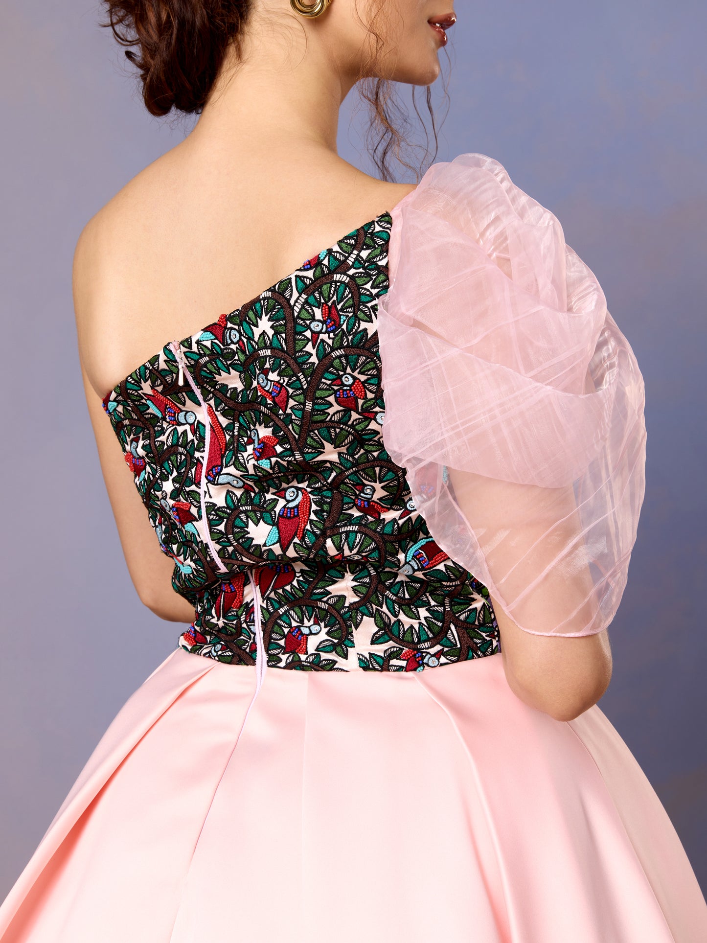Close-up of floral embroidered bodice and puff sleeve on coral blush gown