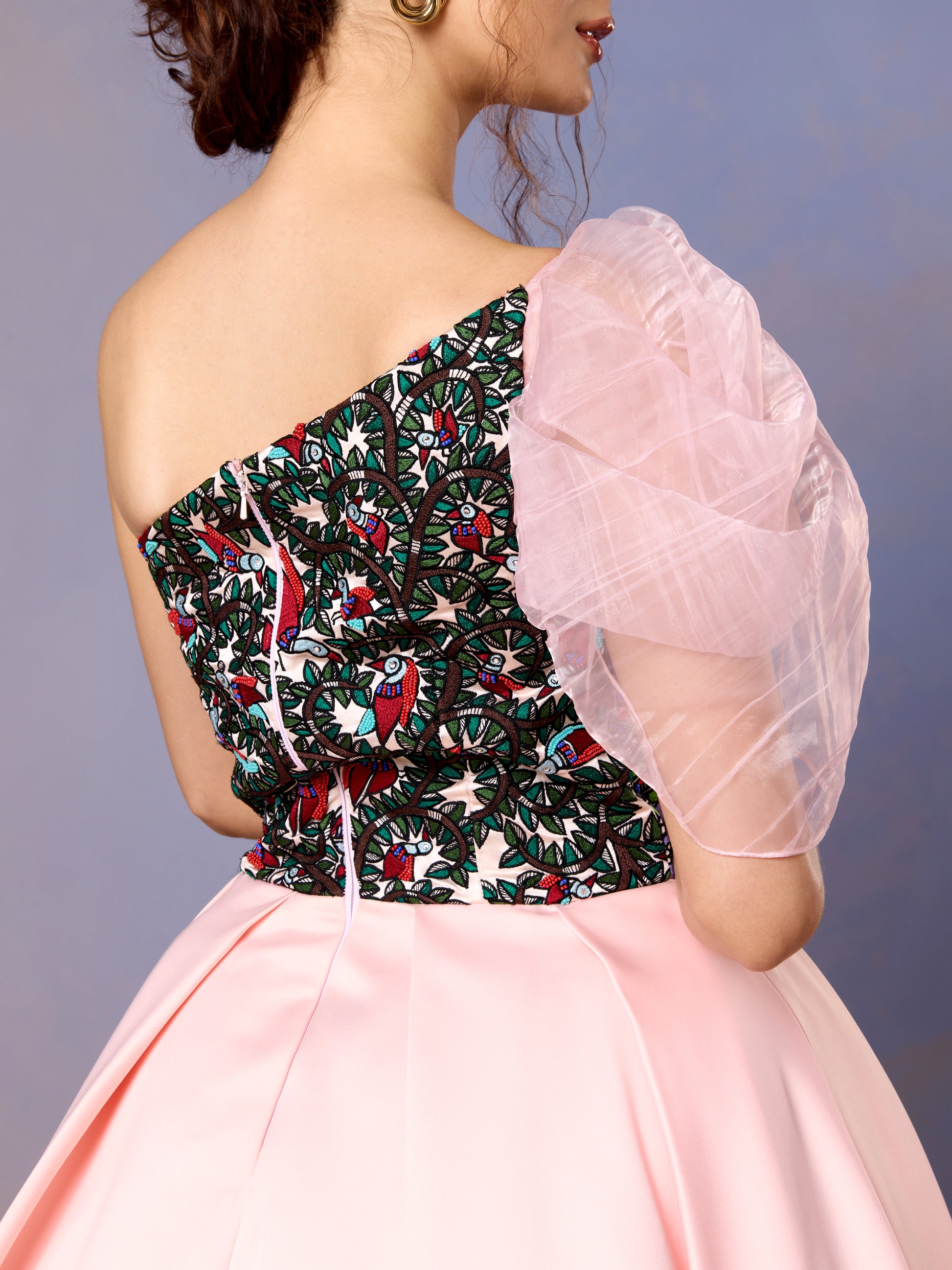 Close-up of floral embroidered bodice and puff sleeve on coral blush gown