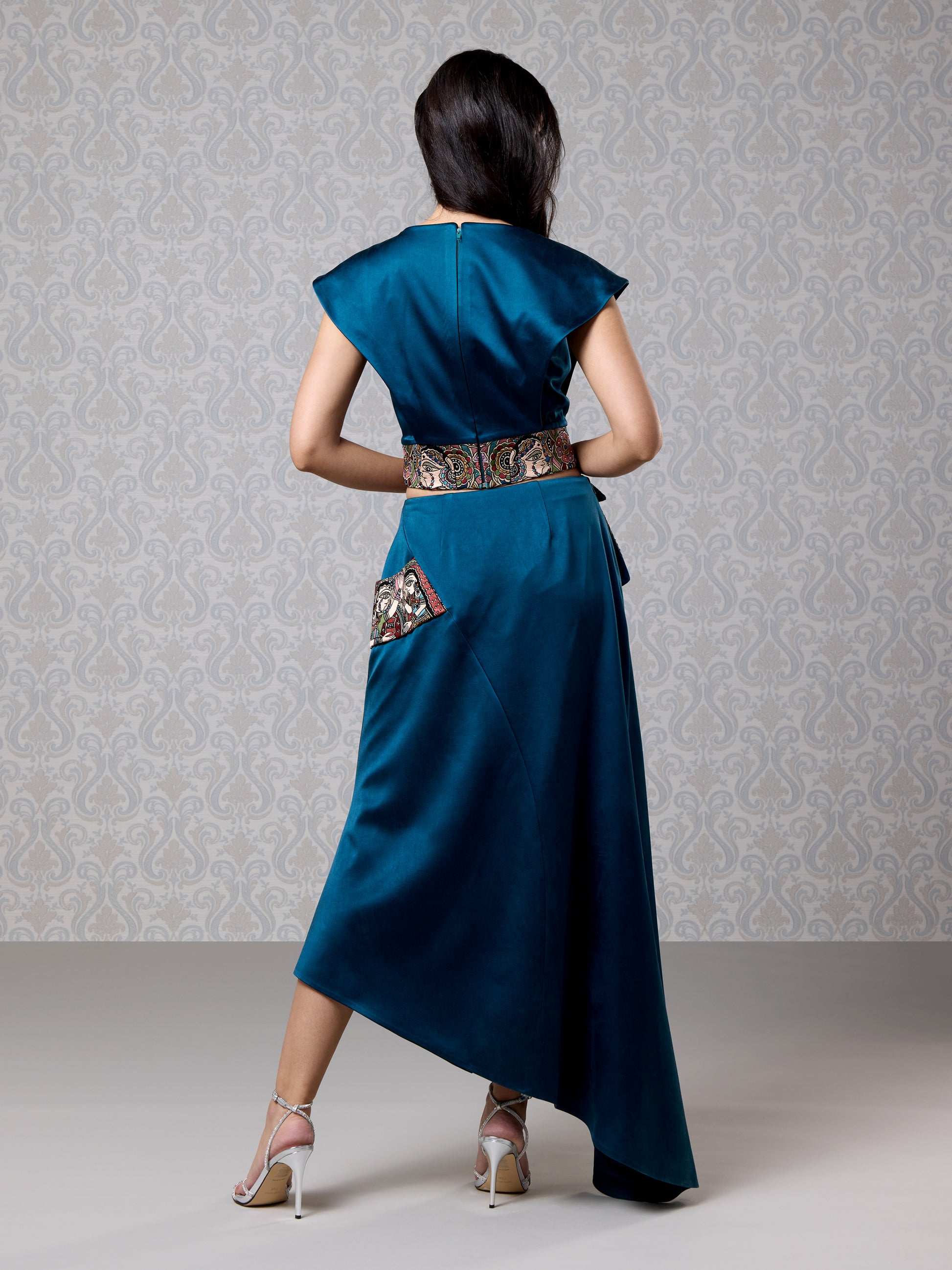 Back view of moonlight blue satin co-ord with asymmetrical drape