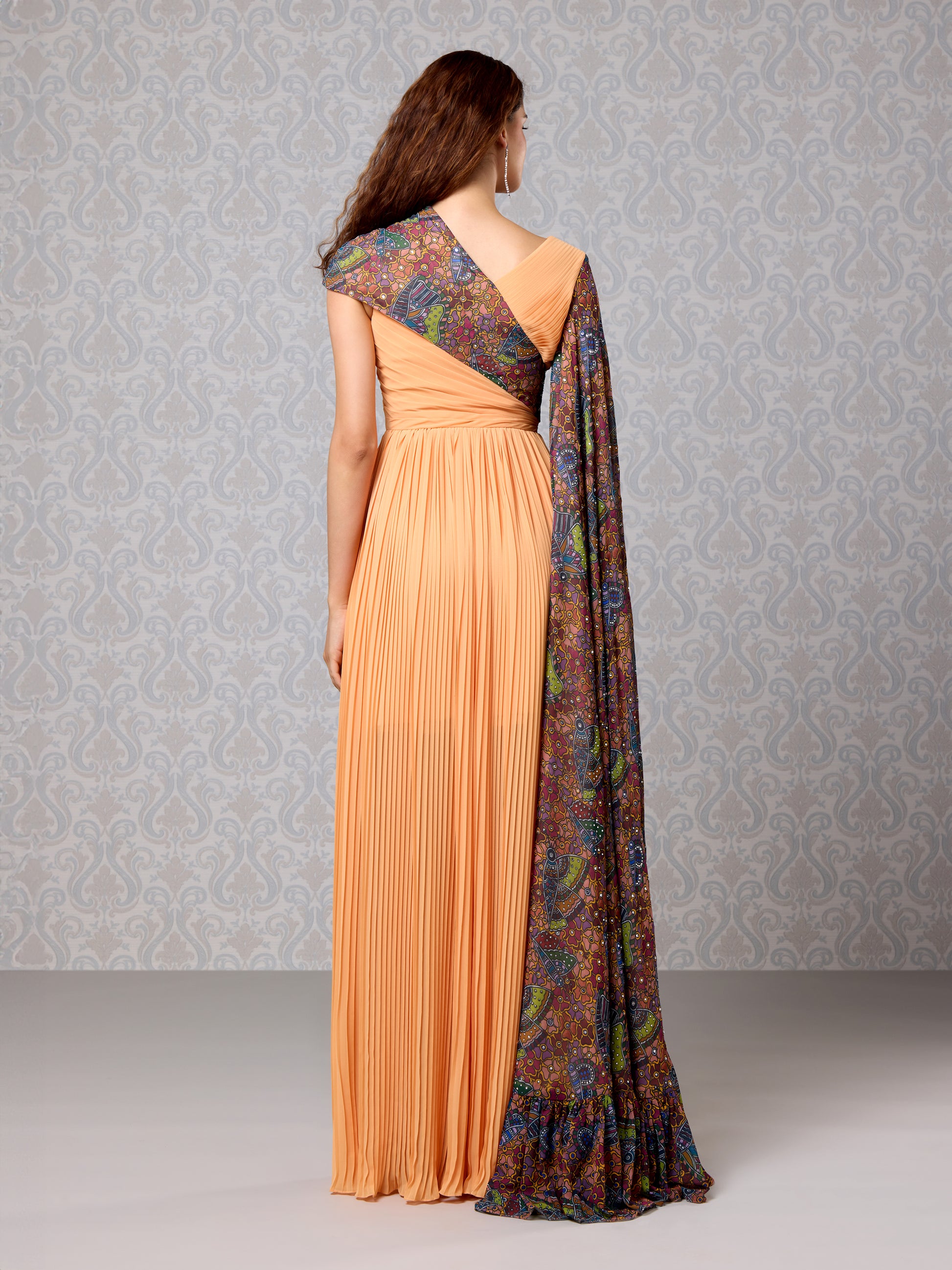Back view of pastel pumpkin georgette gown with vibrant printed cape drape