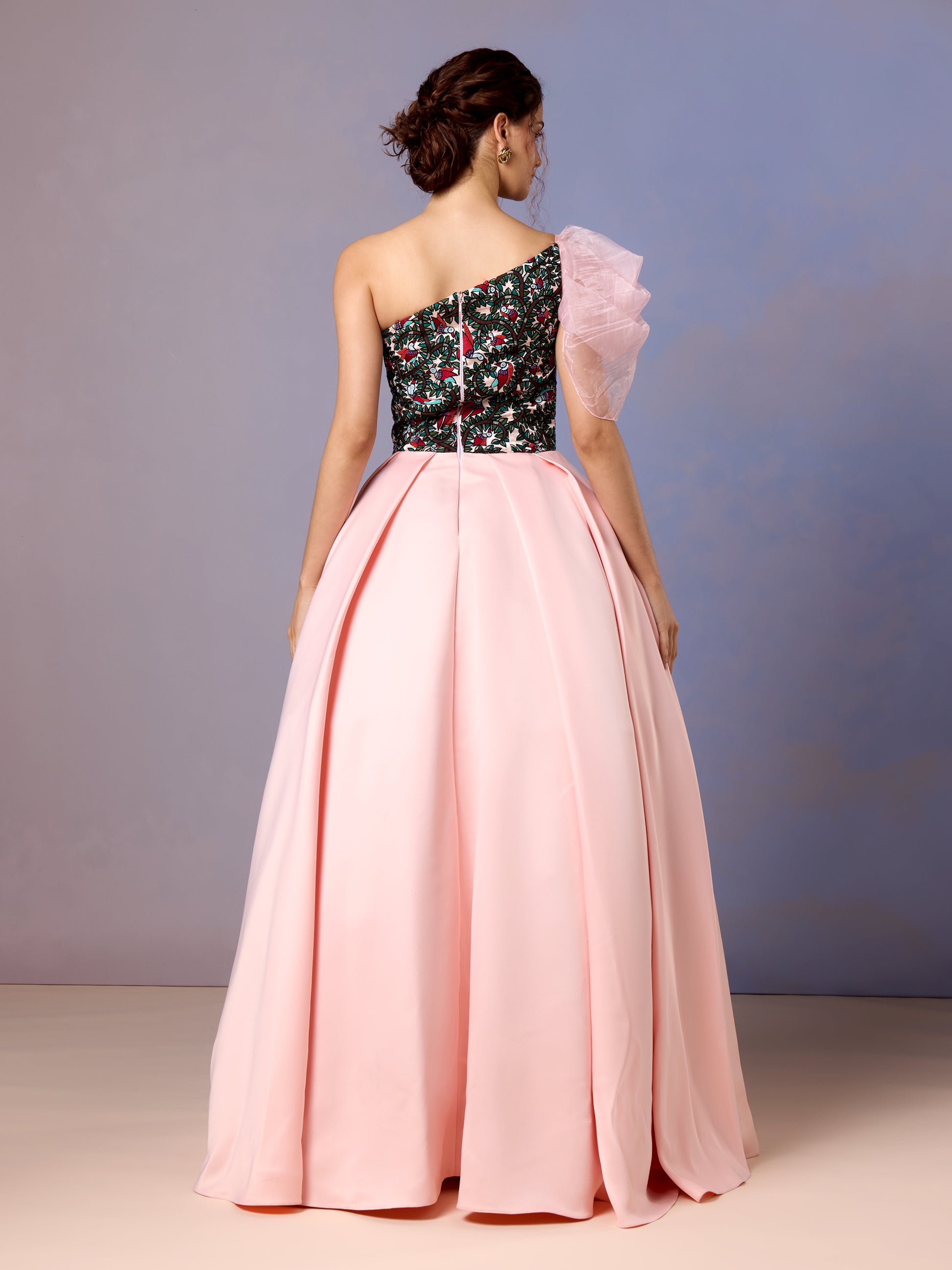 Back view of coral blush silk gown with structured skirt and floral detailing