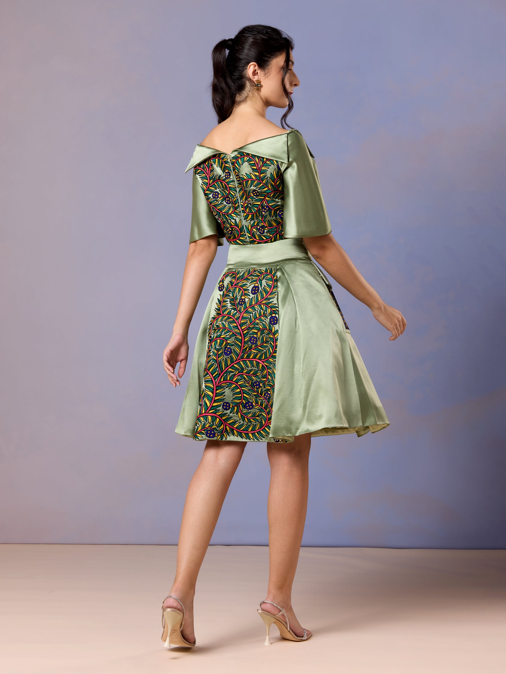 Back view of sage whisper green two-piece skirt set with embroidered panels
