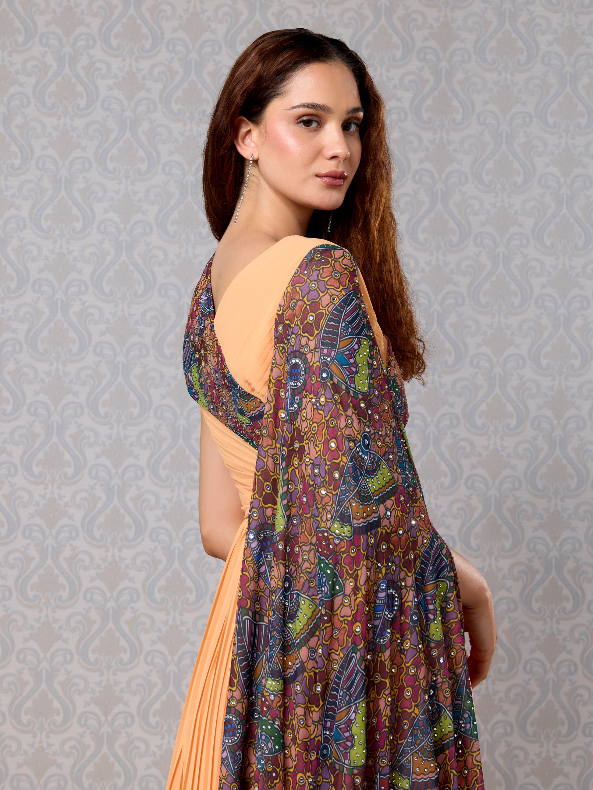 Side pose of pastel pumpkin long dress featuring colorful printed overlay