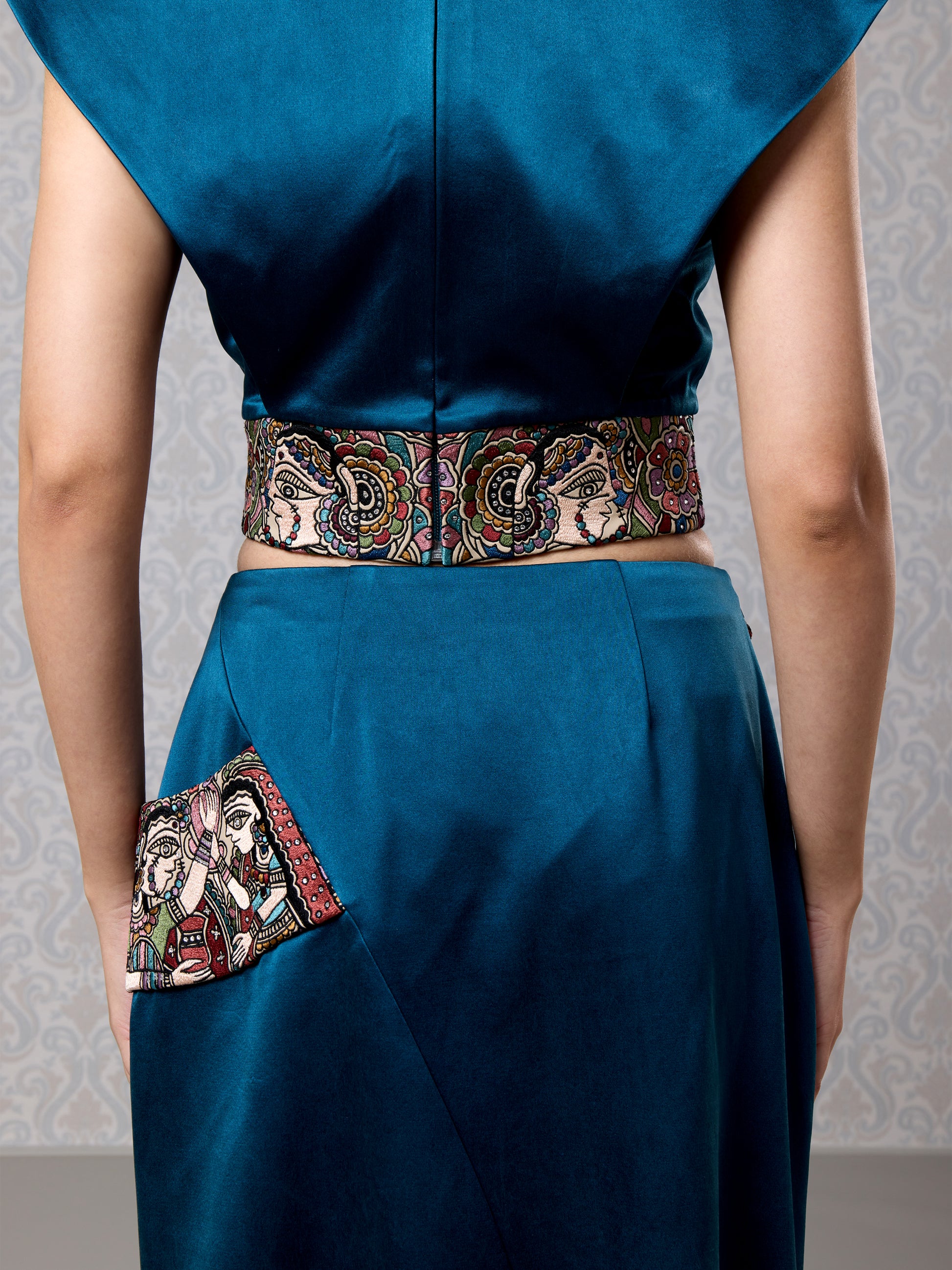 Back  close-up view of embroidered vegan leather belt on moonlight blue satin set