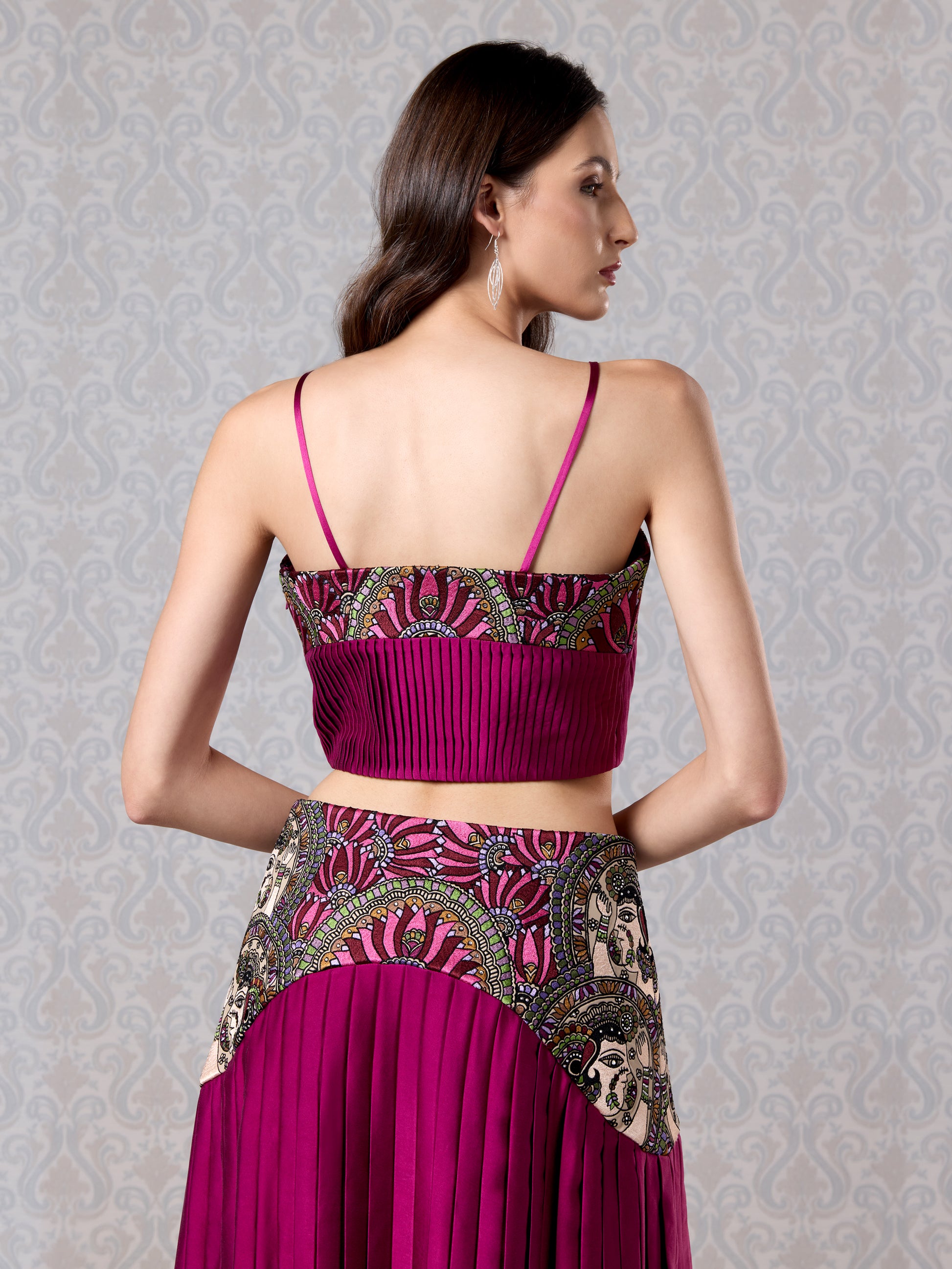 Back view of strappy cranberry silk satin top and embroidered leather waistband