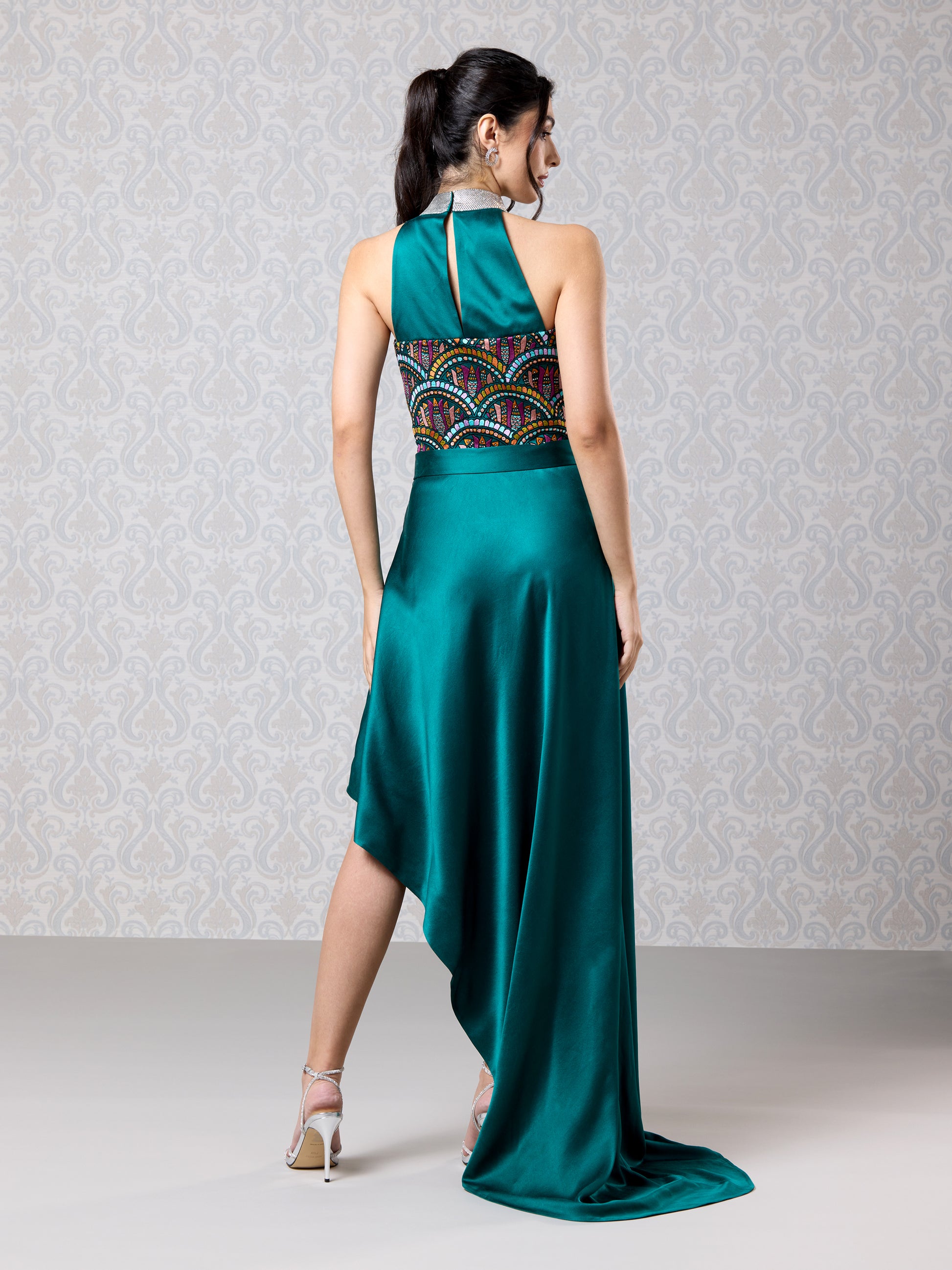 Back view of emerald silk satin asymmetrical dress with elegant drape