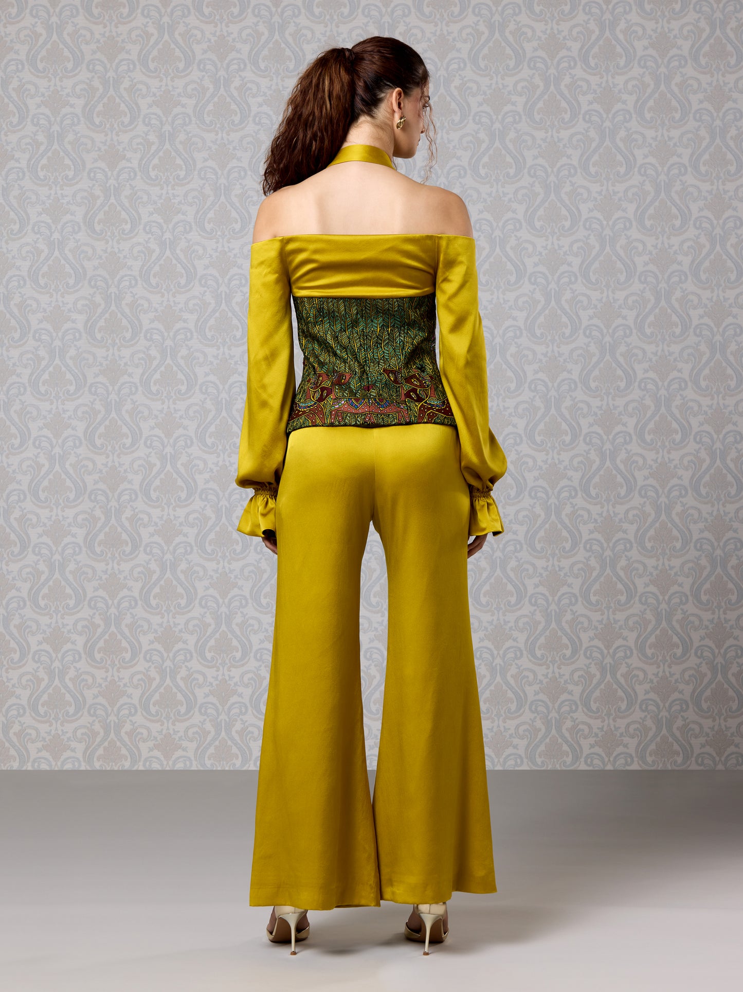 full back pose of harvest gold satin top and flared trouser set