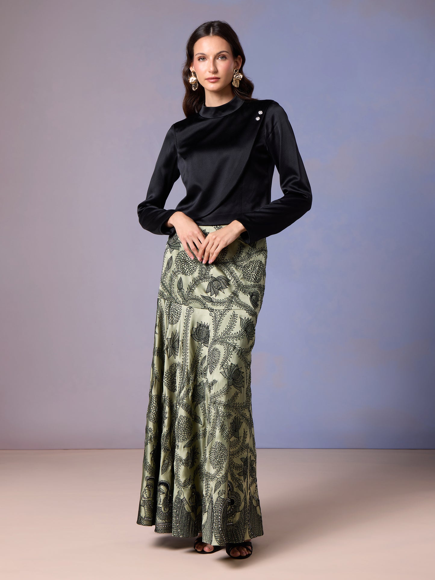 Model styling Sage Whisper green skirt and black top