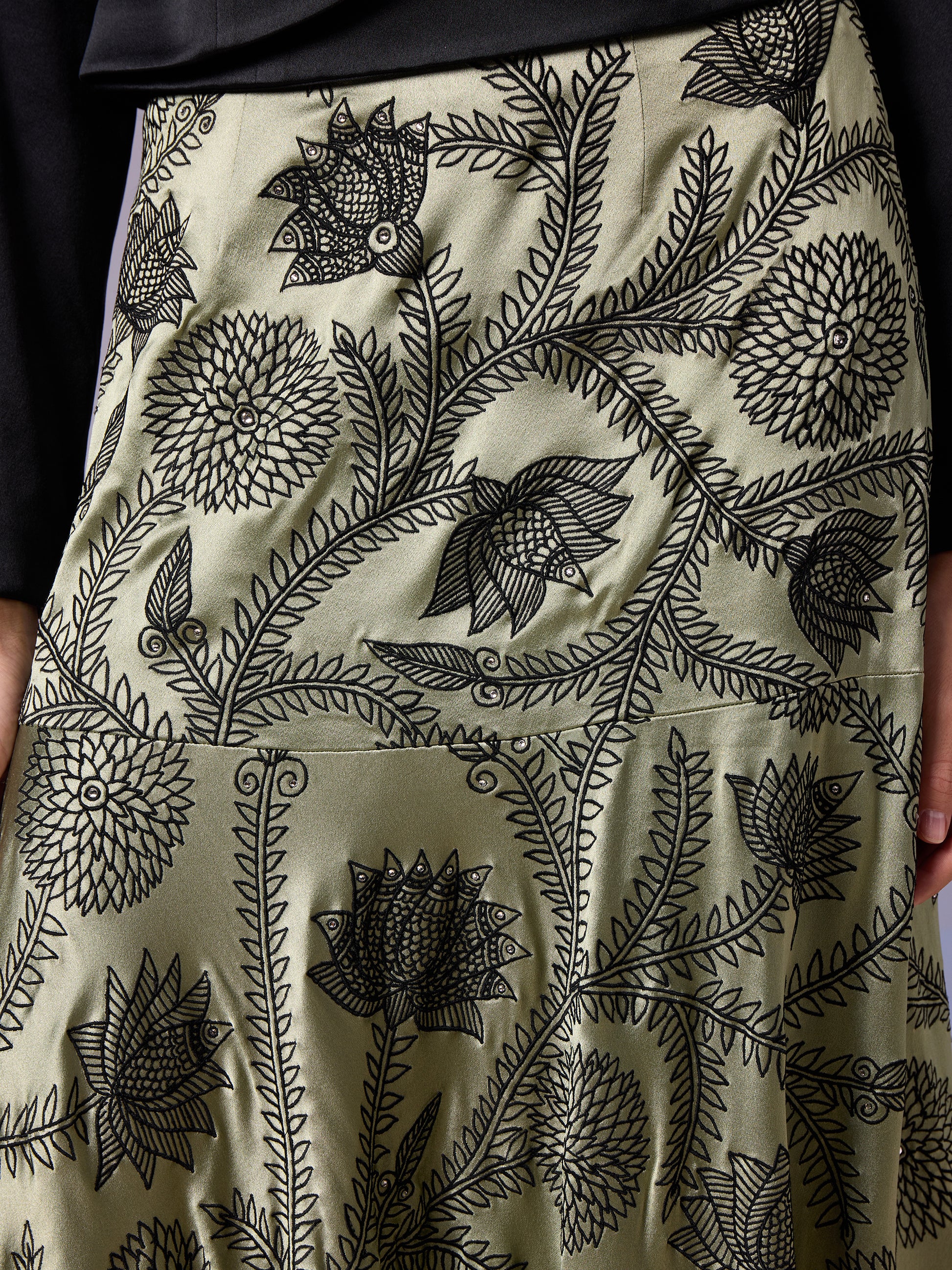 Close-up of Sage Whisper skirt with abstract green patterns