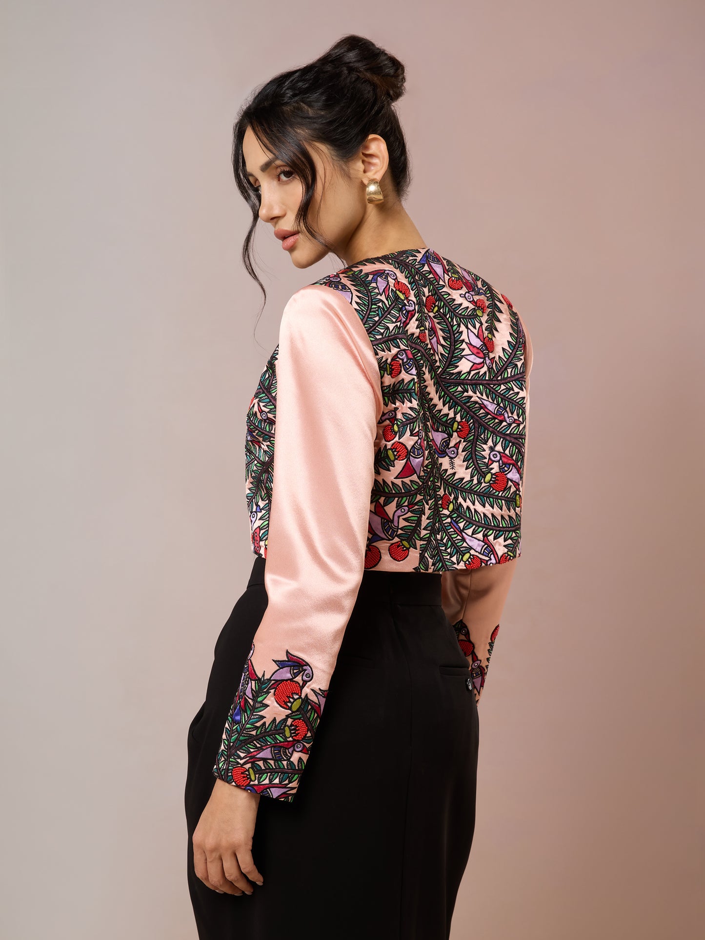 Back view of embroidered satin crop jacket in pink and black