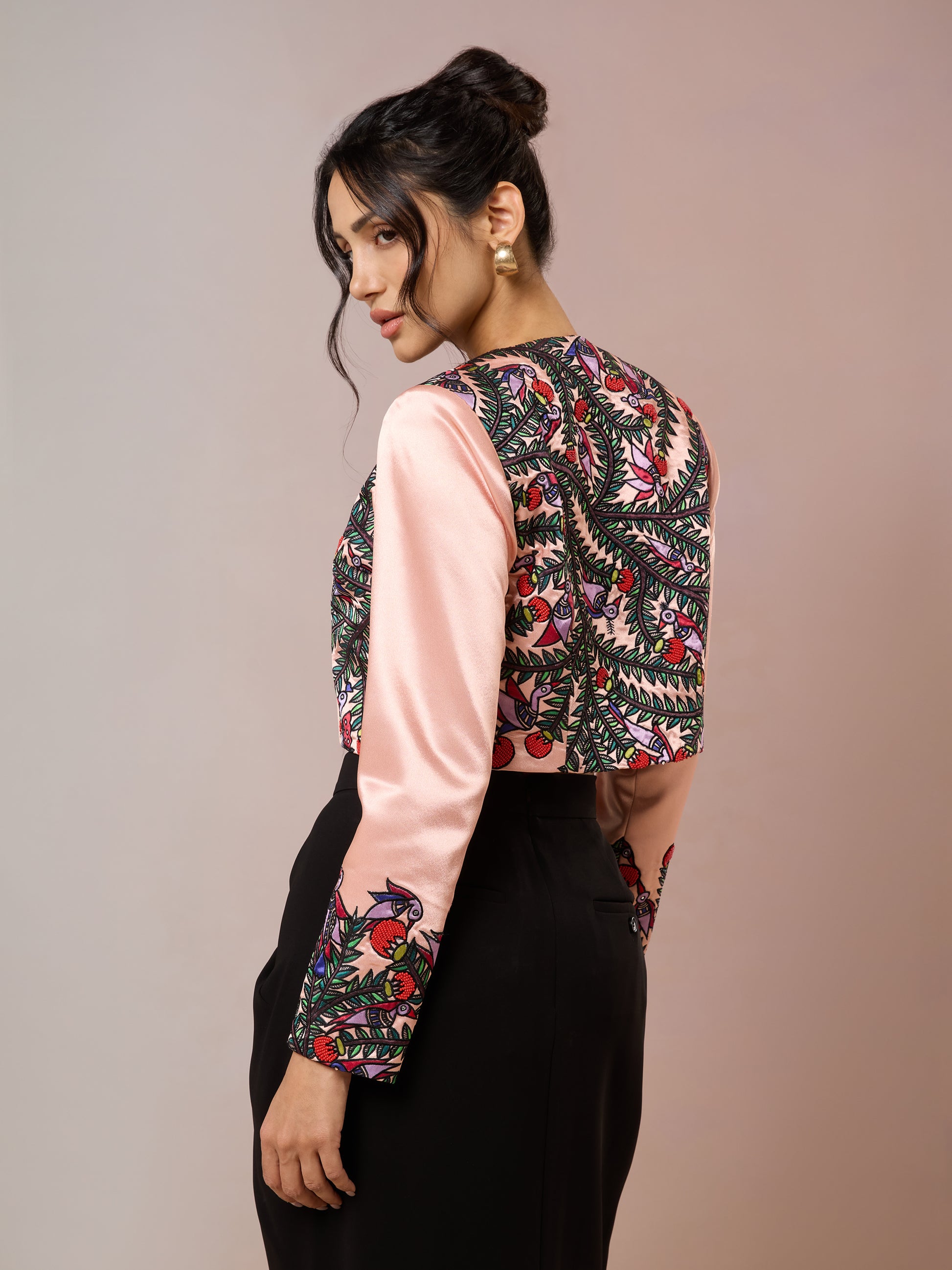 Back view of embroidered satin crop jacket in pink and black
