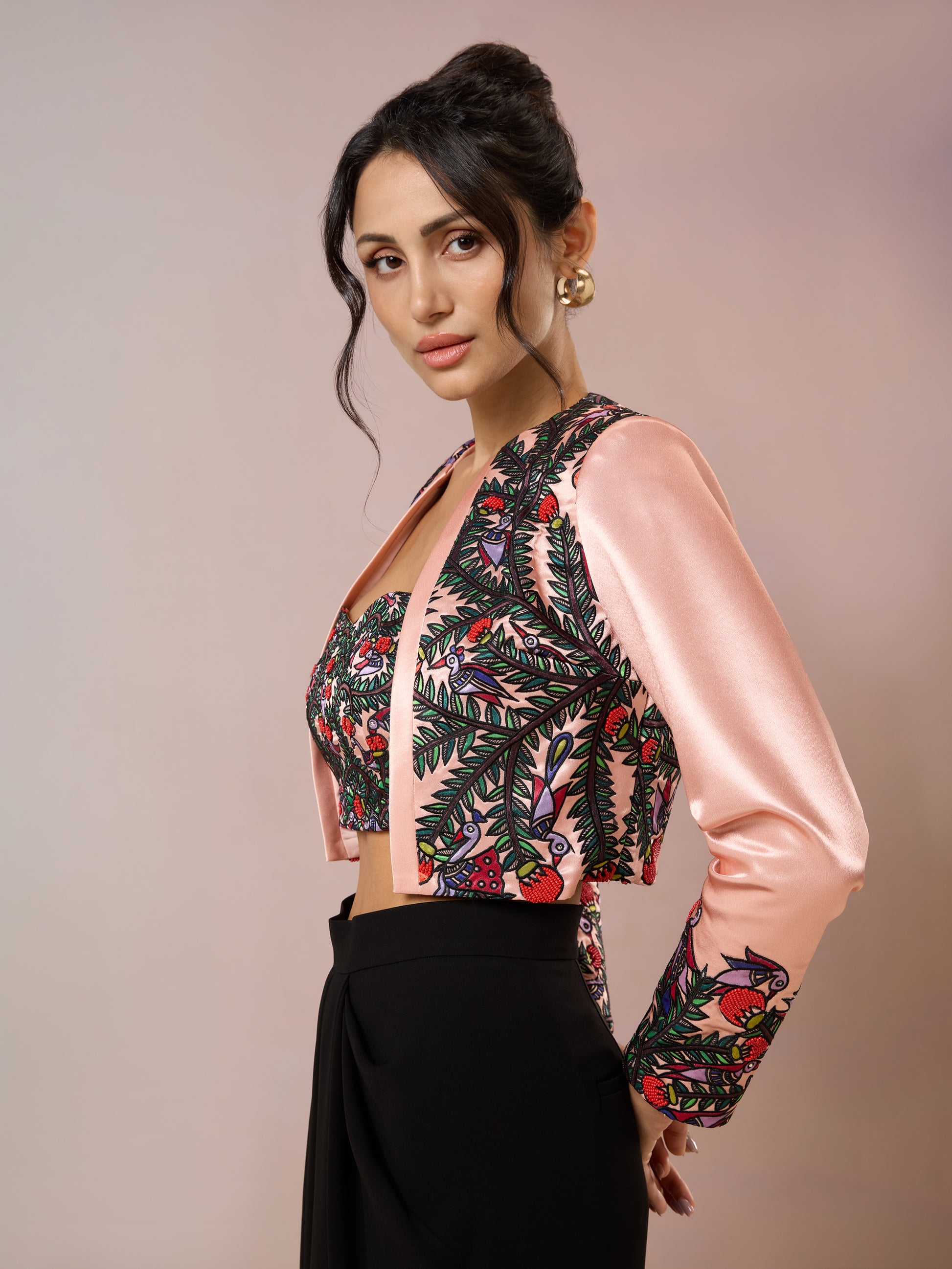 Side view of pink satin embroidered jacket over matching bustier