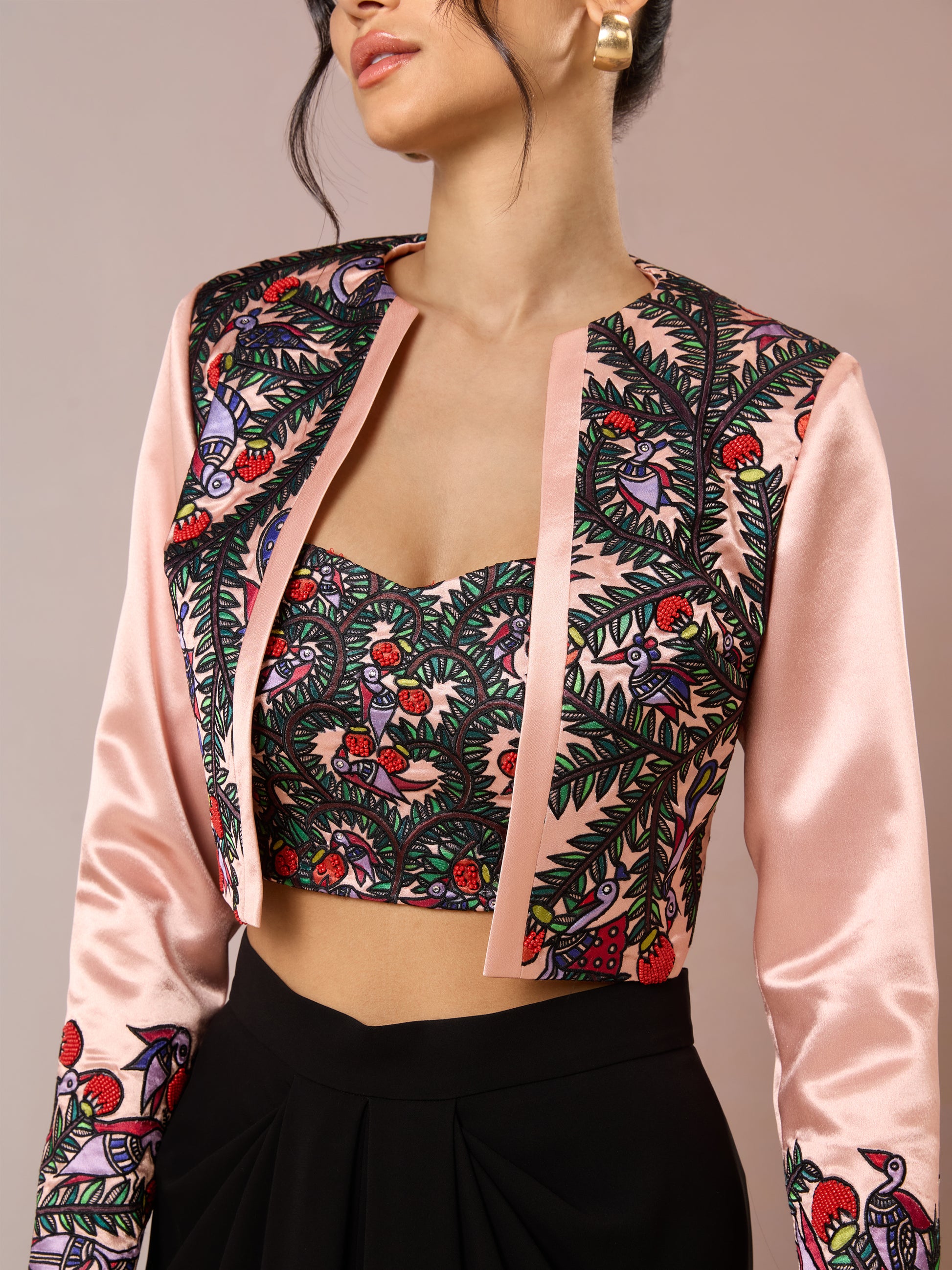 Close-up of floral embroidered bustier with satin jacket detail