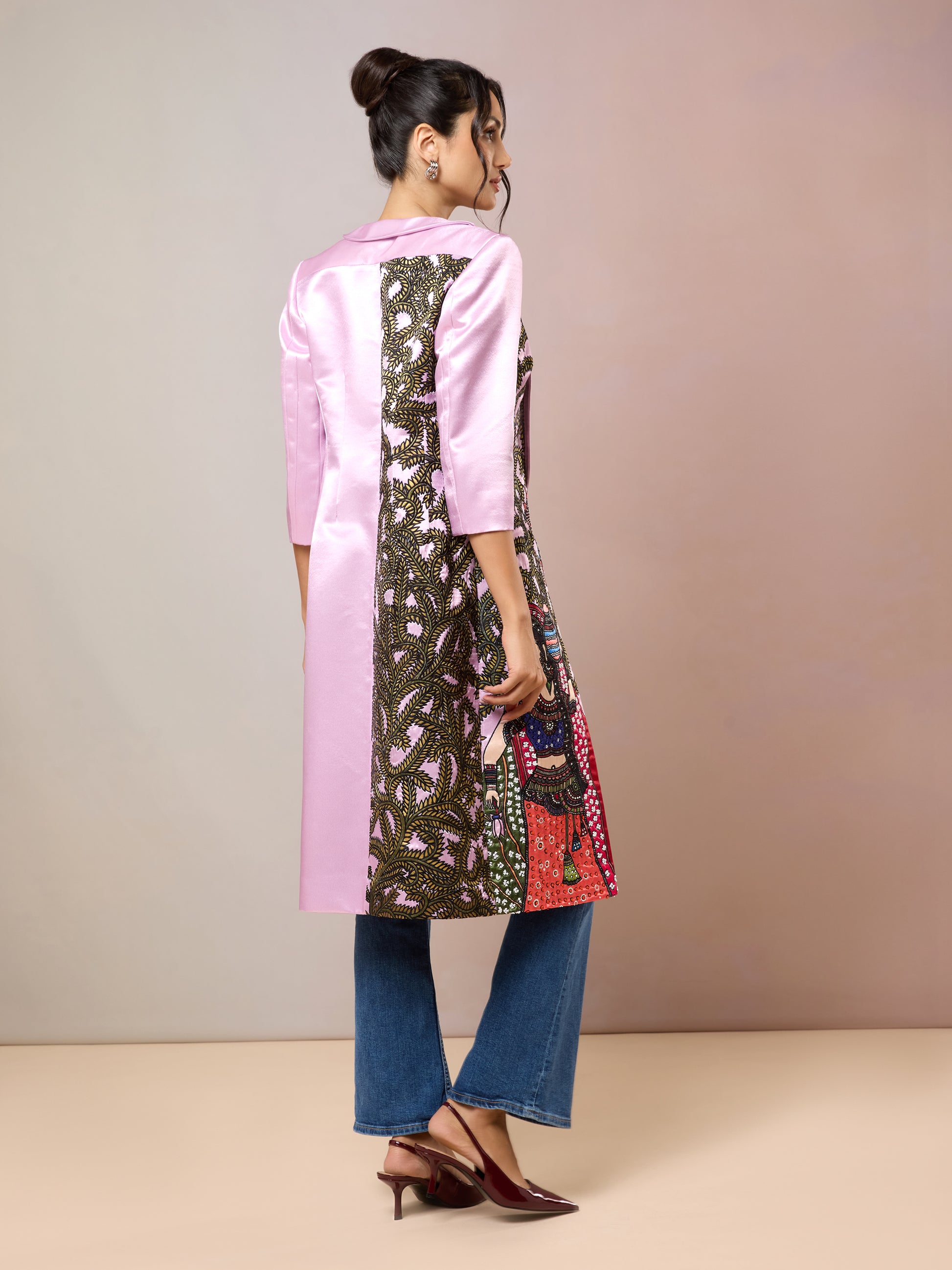 Back view of long pink jacket with vibrant folk art design