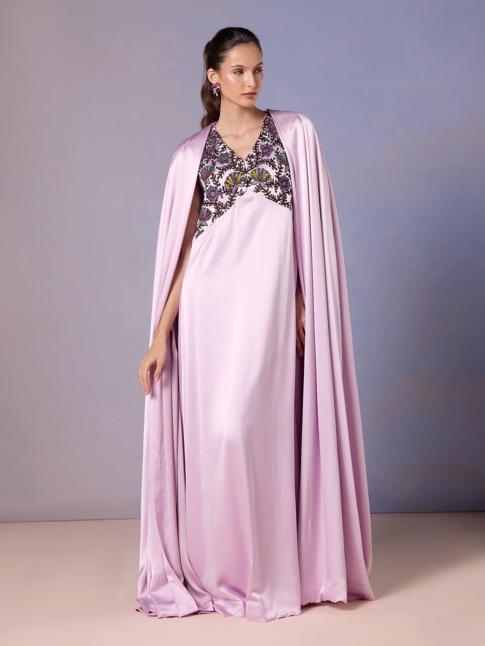 Model in French Lilac silk kaftan with embroidered neckline and cape sleeves