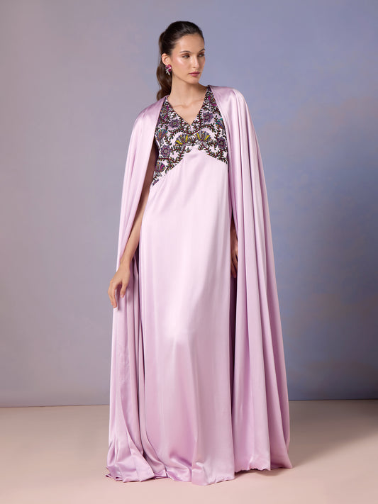 Model in French Lilac silk kaftan with embroidered neckline and cape sleeves