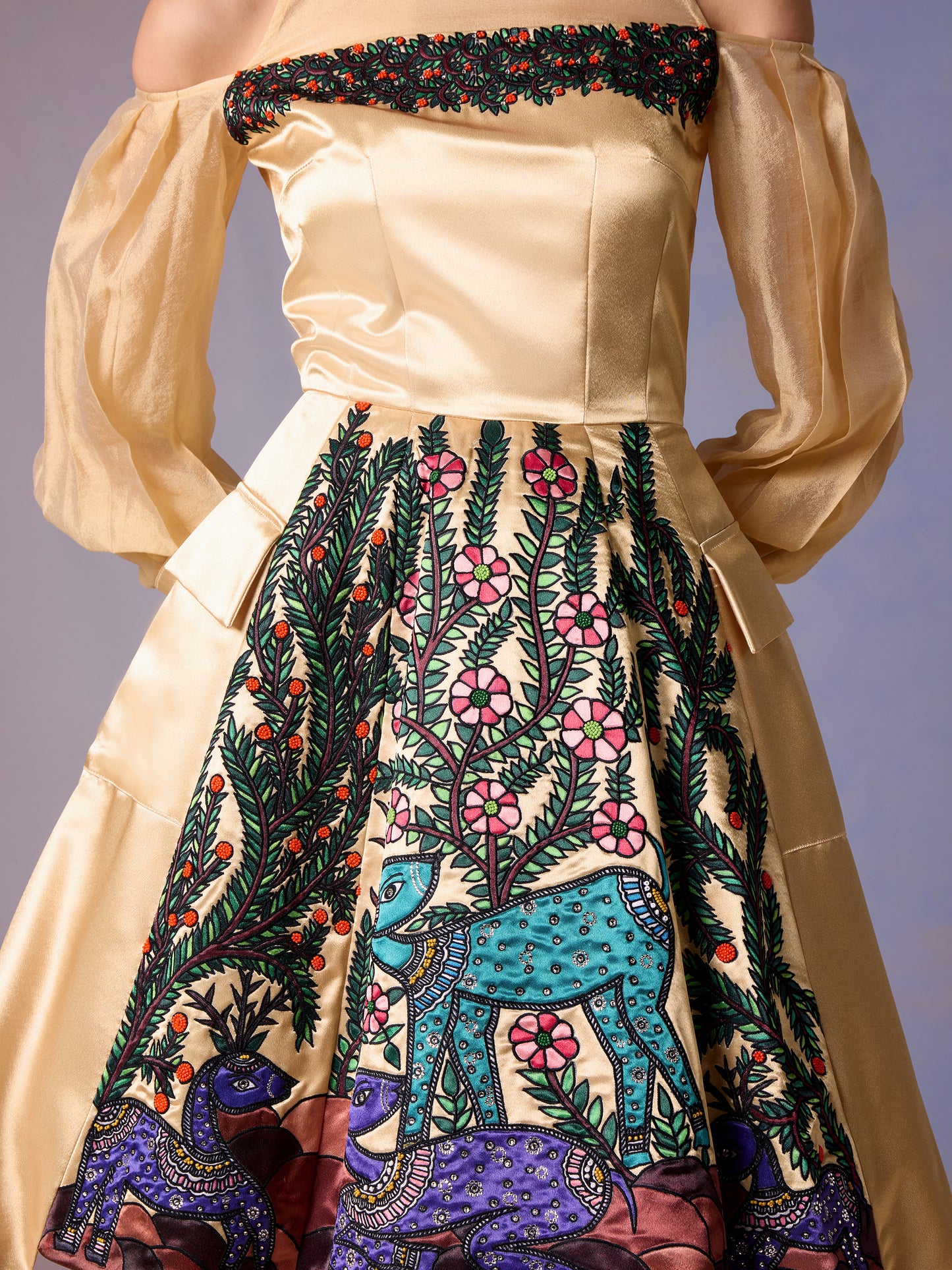 Close-up of gold bodice and embroidered skirt on Morning Light short dress