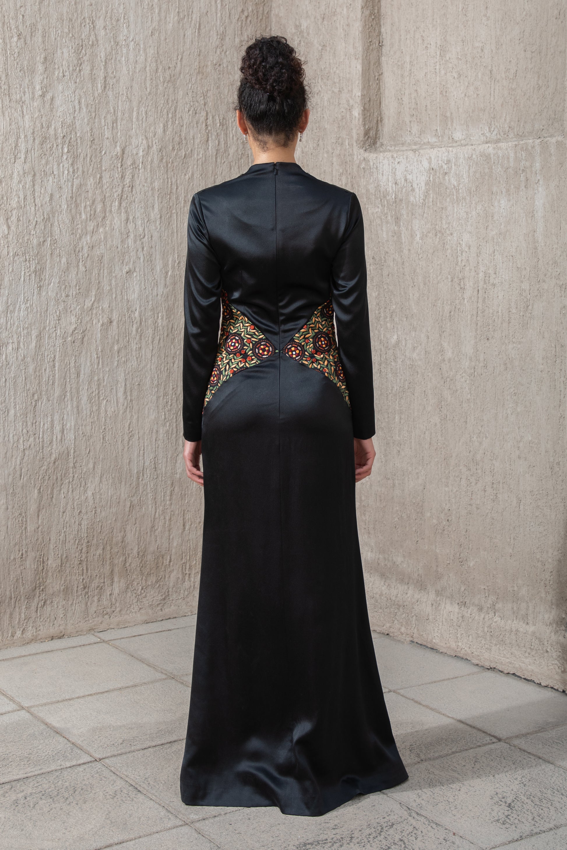 Back view of black gown with flowing cape