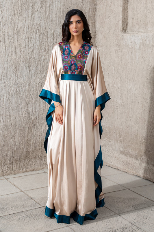 Model in vanilla kaftan with moonlight blue trim and embroidered neckline