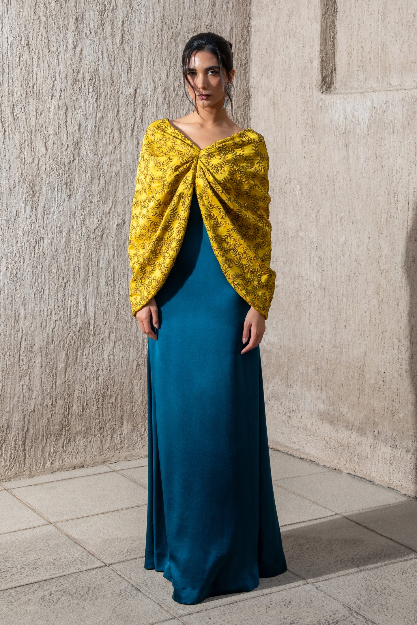 Model in harvest gold top and moonlight blue kaftan dress