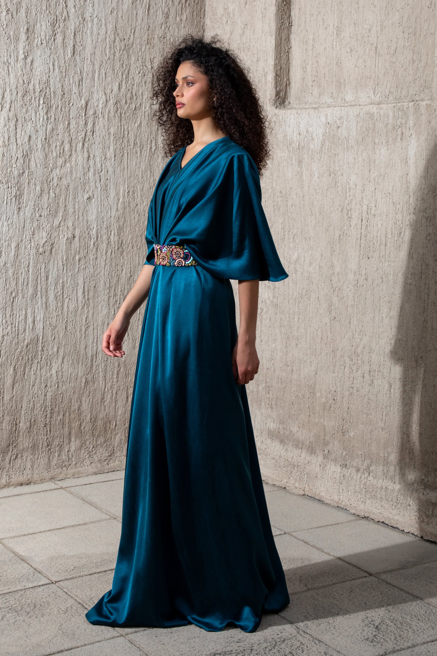 Side profile of moonlight blue satin gown with kimono sleeves