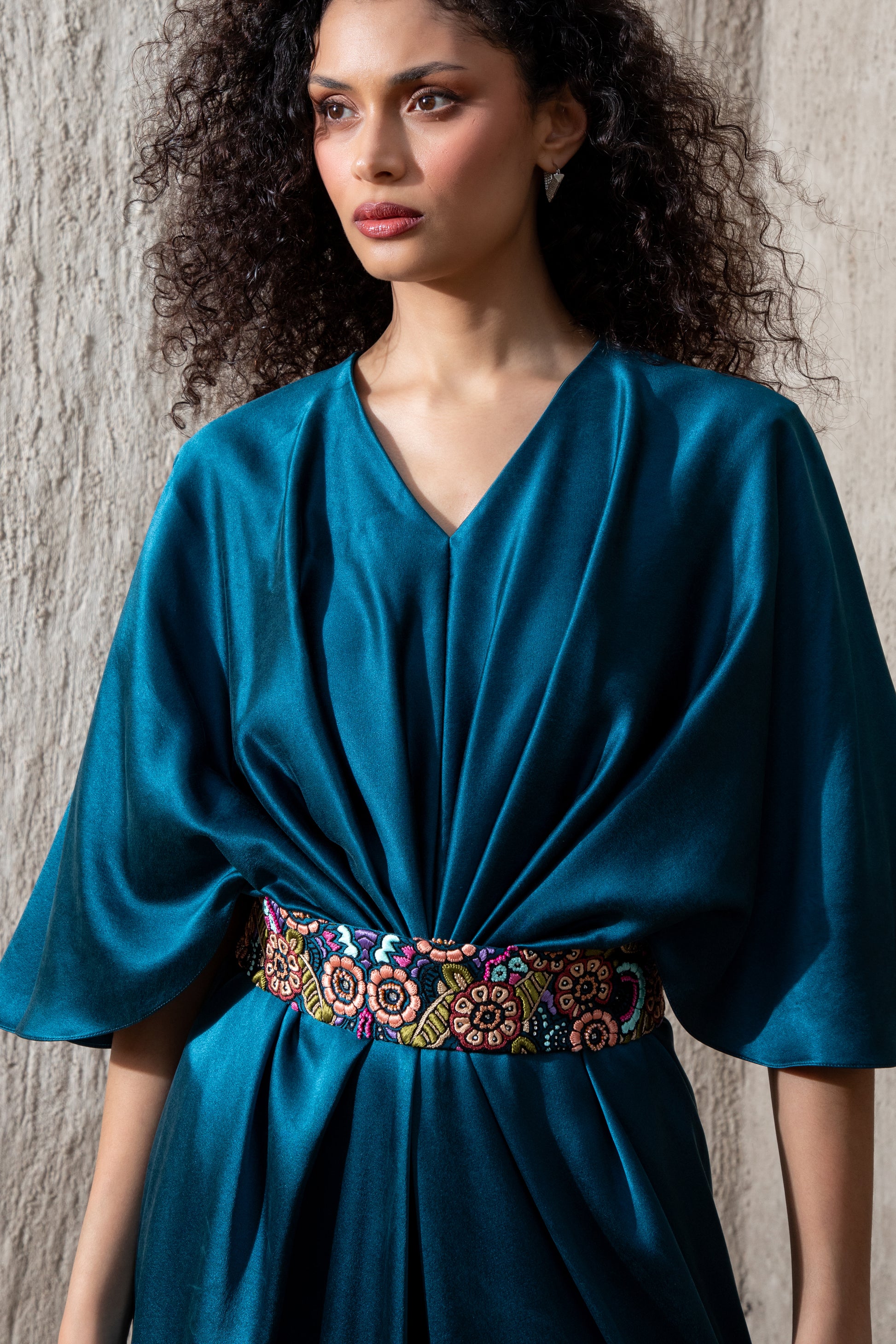 Close-up of moonlight blue gown with intricate waist embellishment