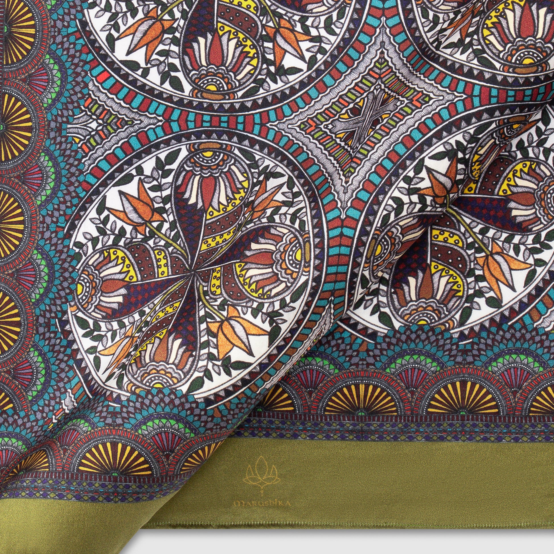 Close-up view of Madhubani silk scarf with olive green border and vibrant circular motifs