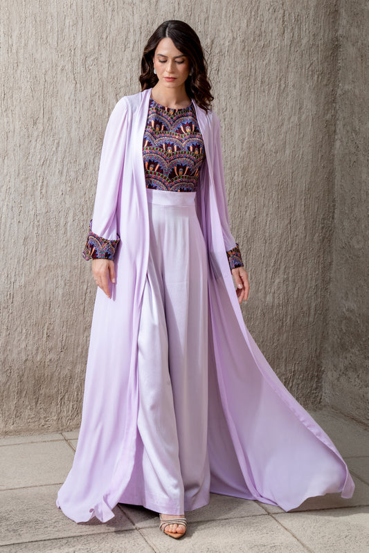 Model walking in Amethyst Haze jumpsuit with flared cape jacket