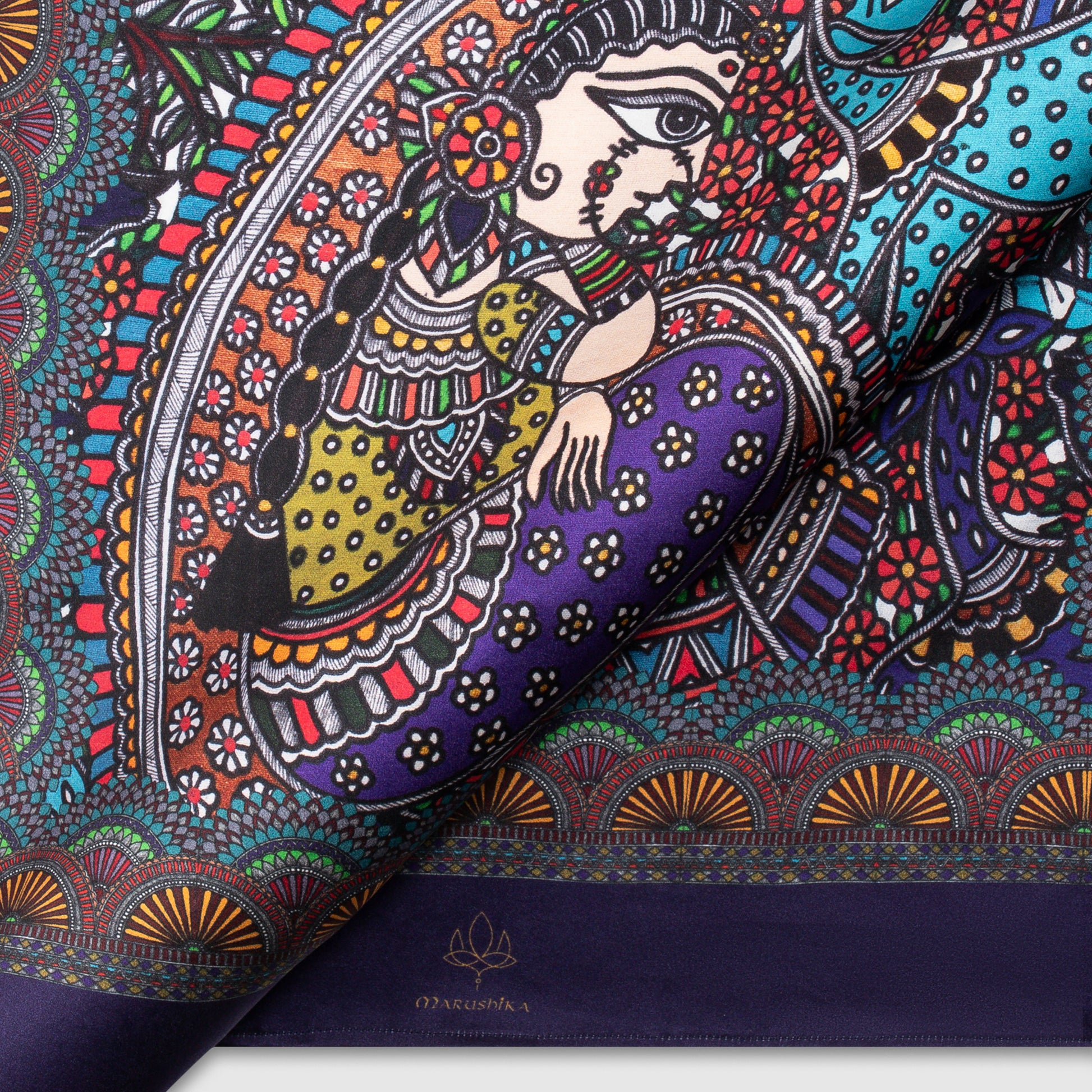 Close-up of Madhubani scarf with vibrant artwork of woman