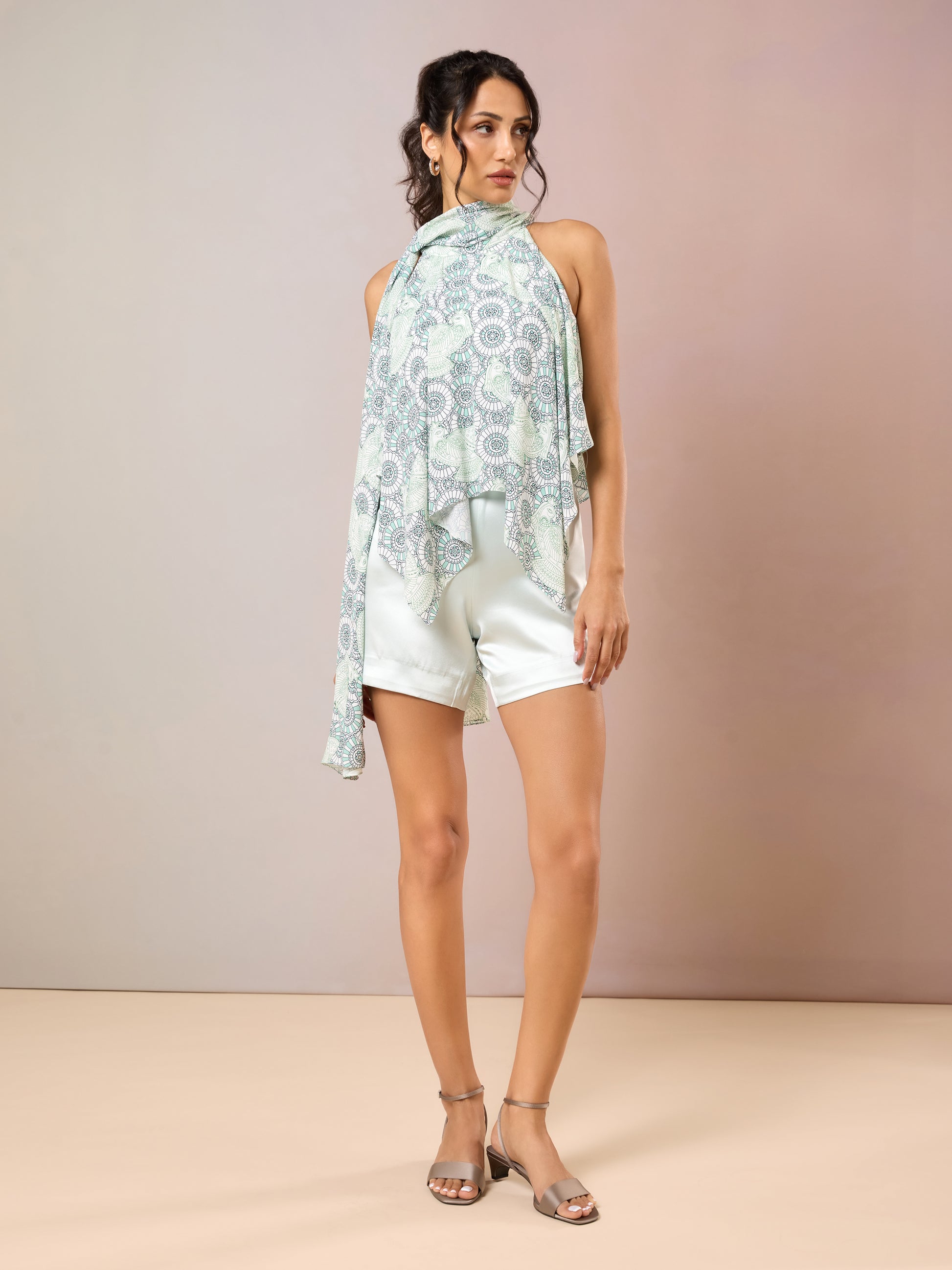 Model in Sea Glass printed top with white high-waist shorts