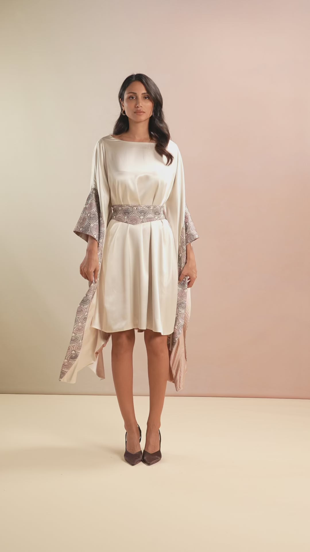 Model walking in Champagne Kaftan dress with flared sleeves