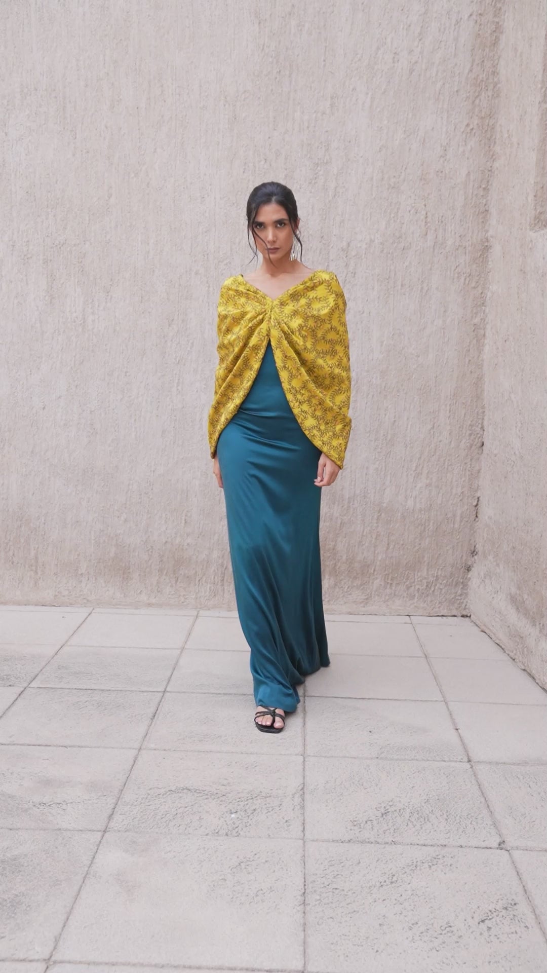Model walking in harvest gold and moonlight blue kaftan ensemble