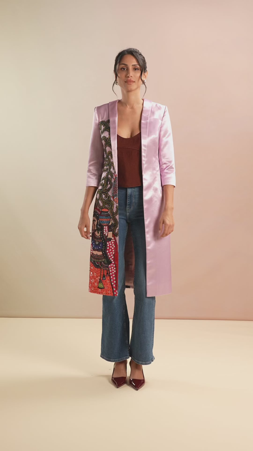 Video of model showcasing pink jacket with Madhubani motif and denim styling