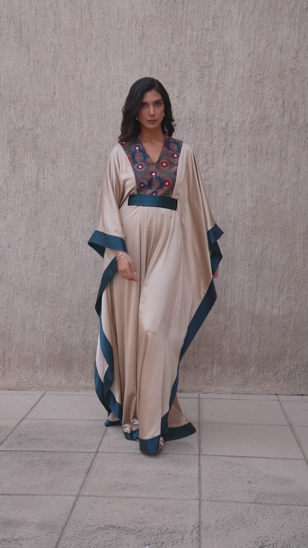 Model walking in vanilla and moonlight blue embroidered kaftan
