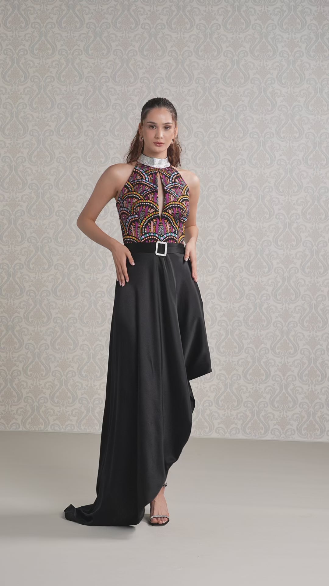 Model walking in Black Ice silk satin long dress with printed halter top and slit skirt