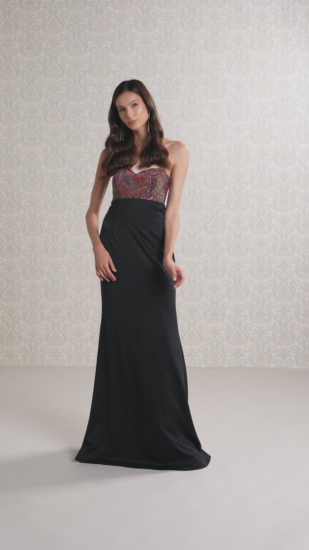 Model walking in sleeveless Black Ice satin crepe gown showcasing its elegant flow