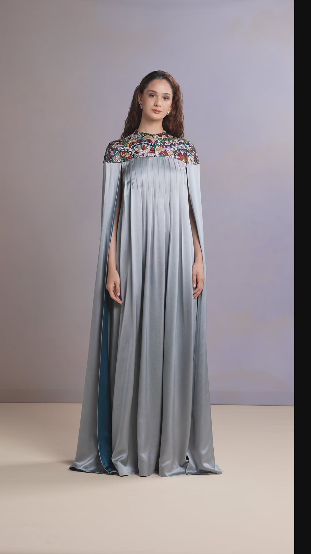 Model showcasing glacier blue embroidered silk kaftan in motion